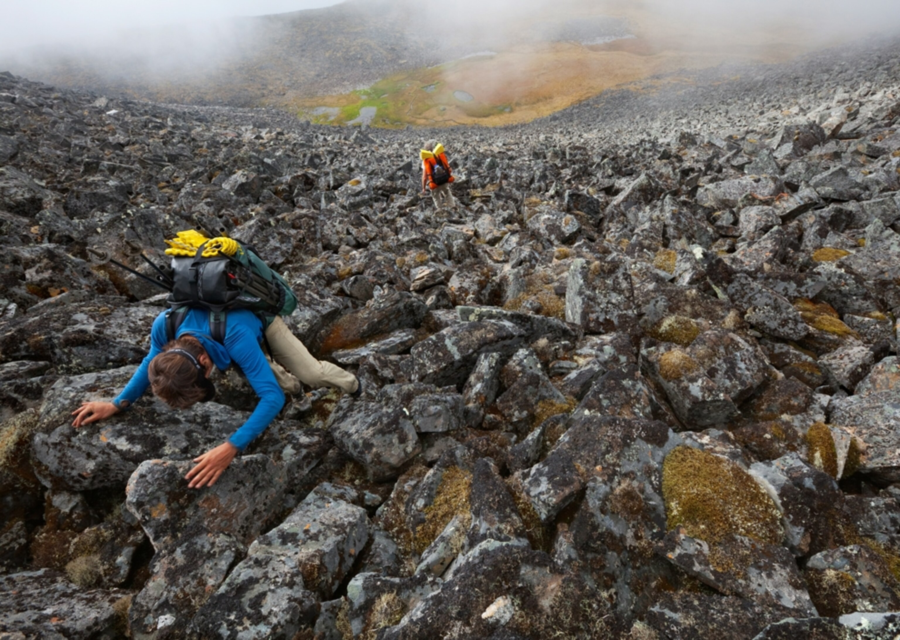 Andrew Skurka climbing boulders along the Arrigetch Creek