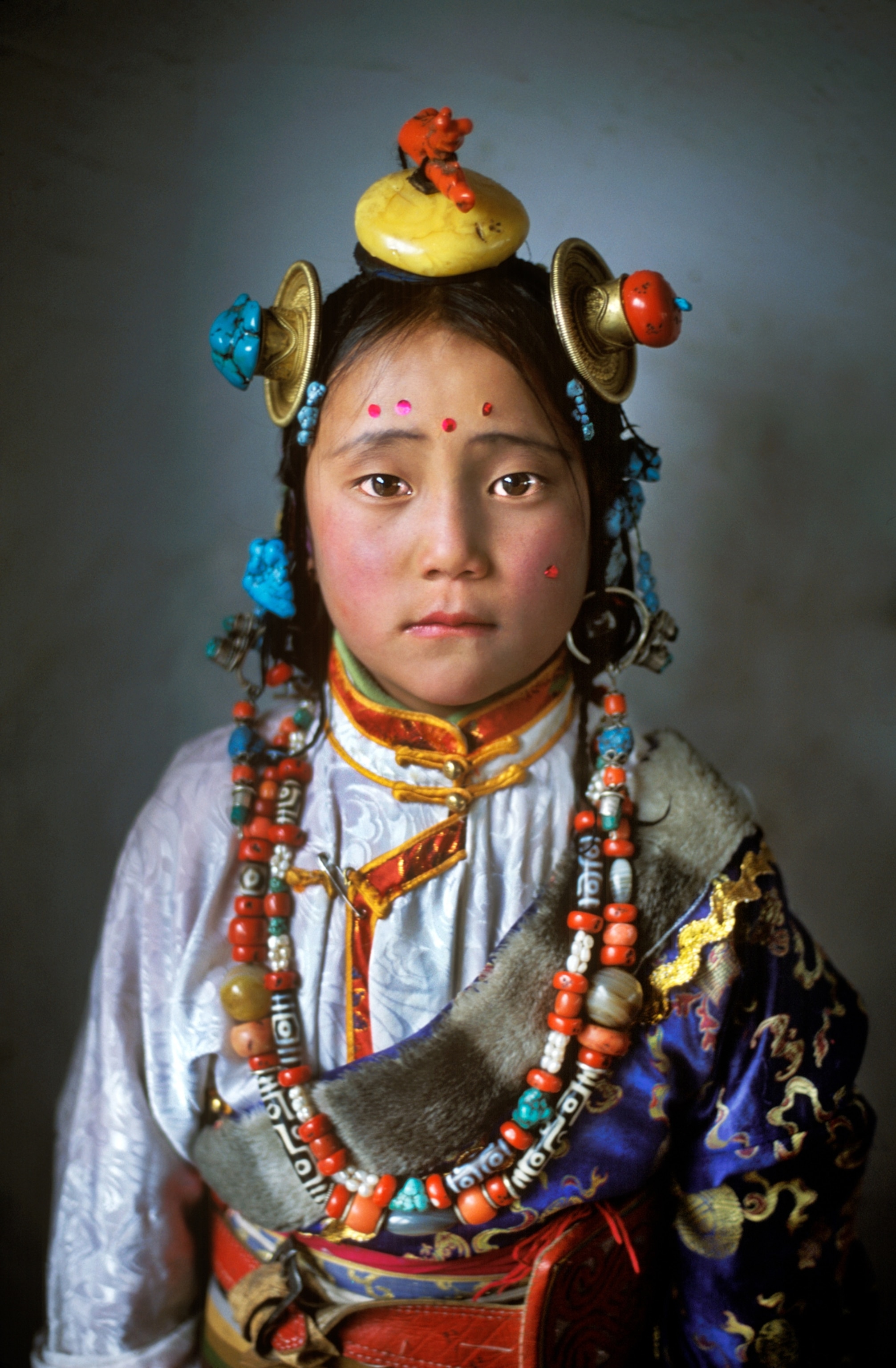 a girl dressed in traditional Tibetan clothing