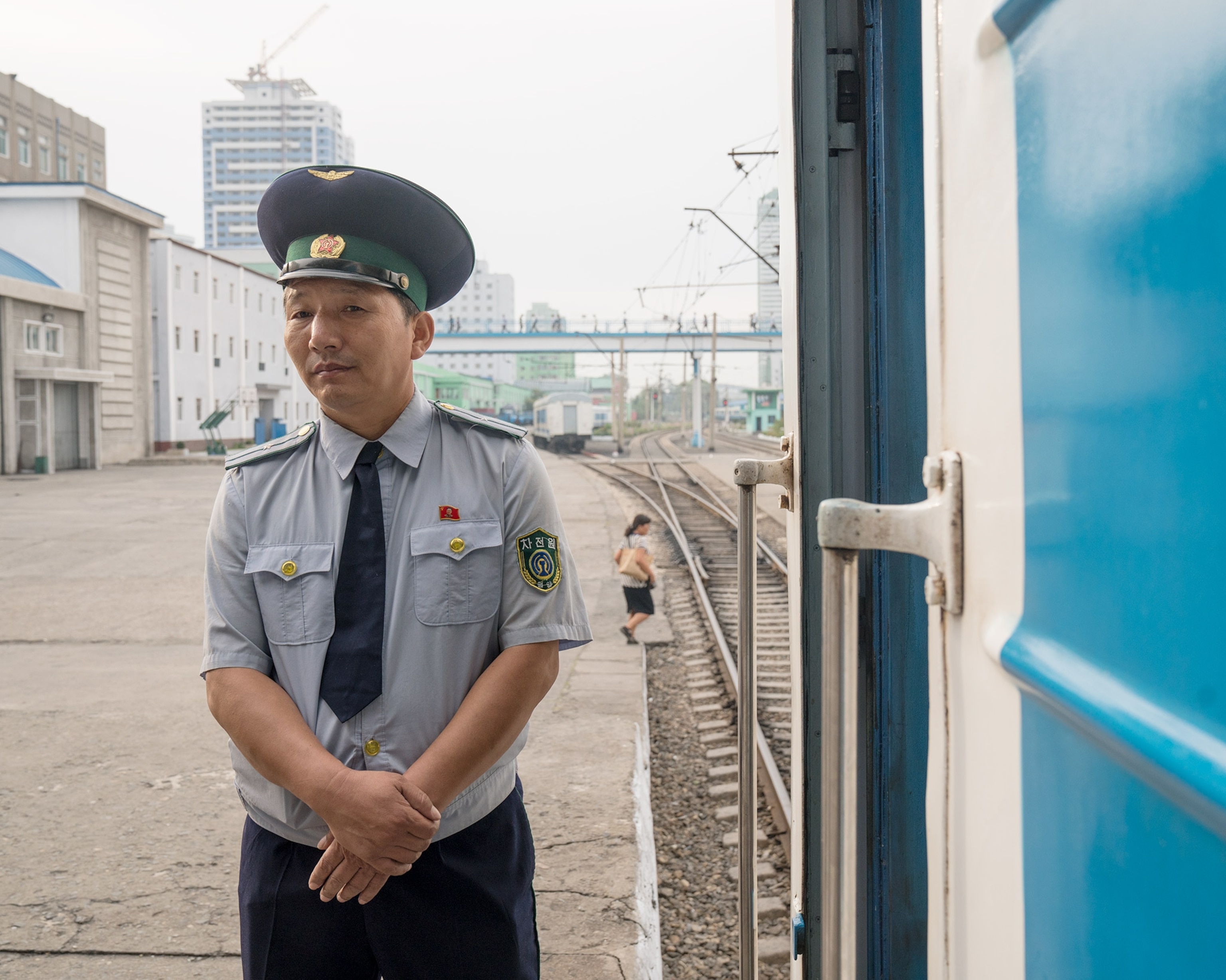 a station agent at a train station in Pyongyang, North Korea
