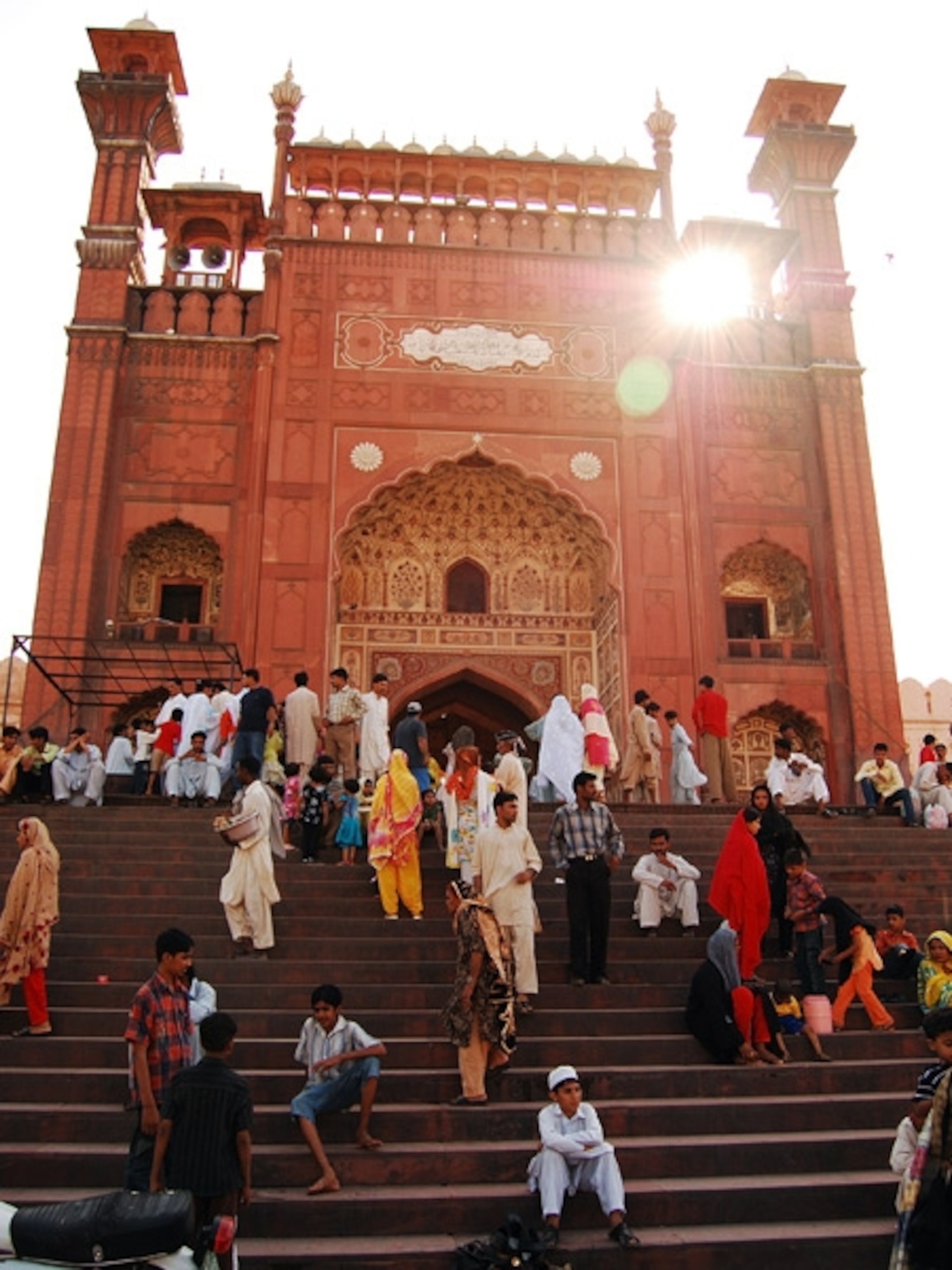 People on stairs in front of a mosque
