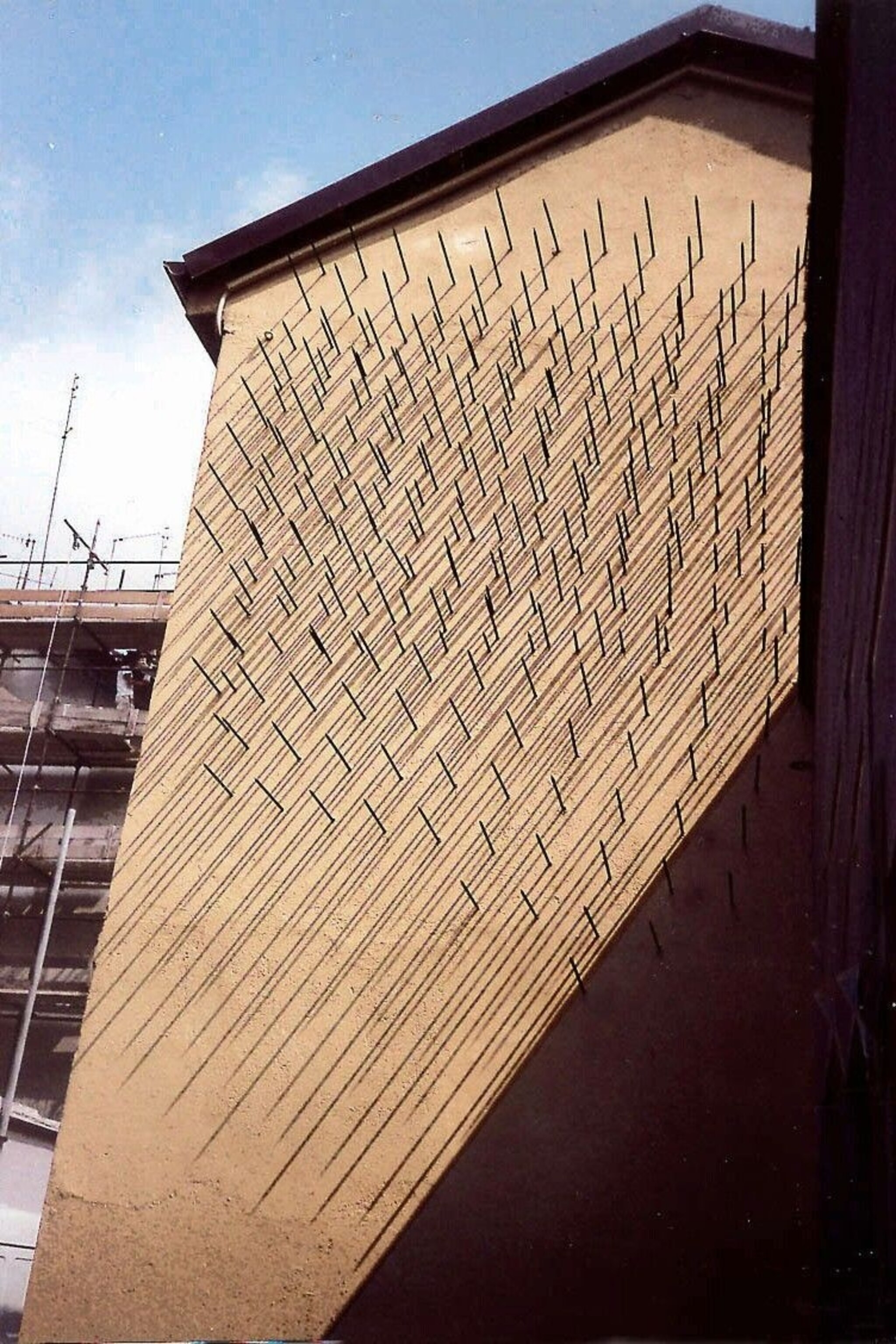 400 metal spikes on a large sheet. The sun shines through it to create patterns with the shadows.