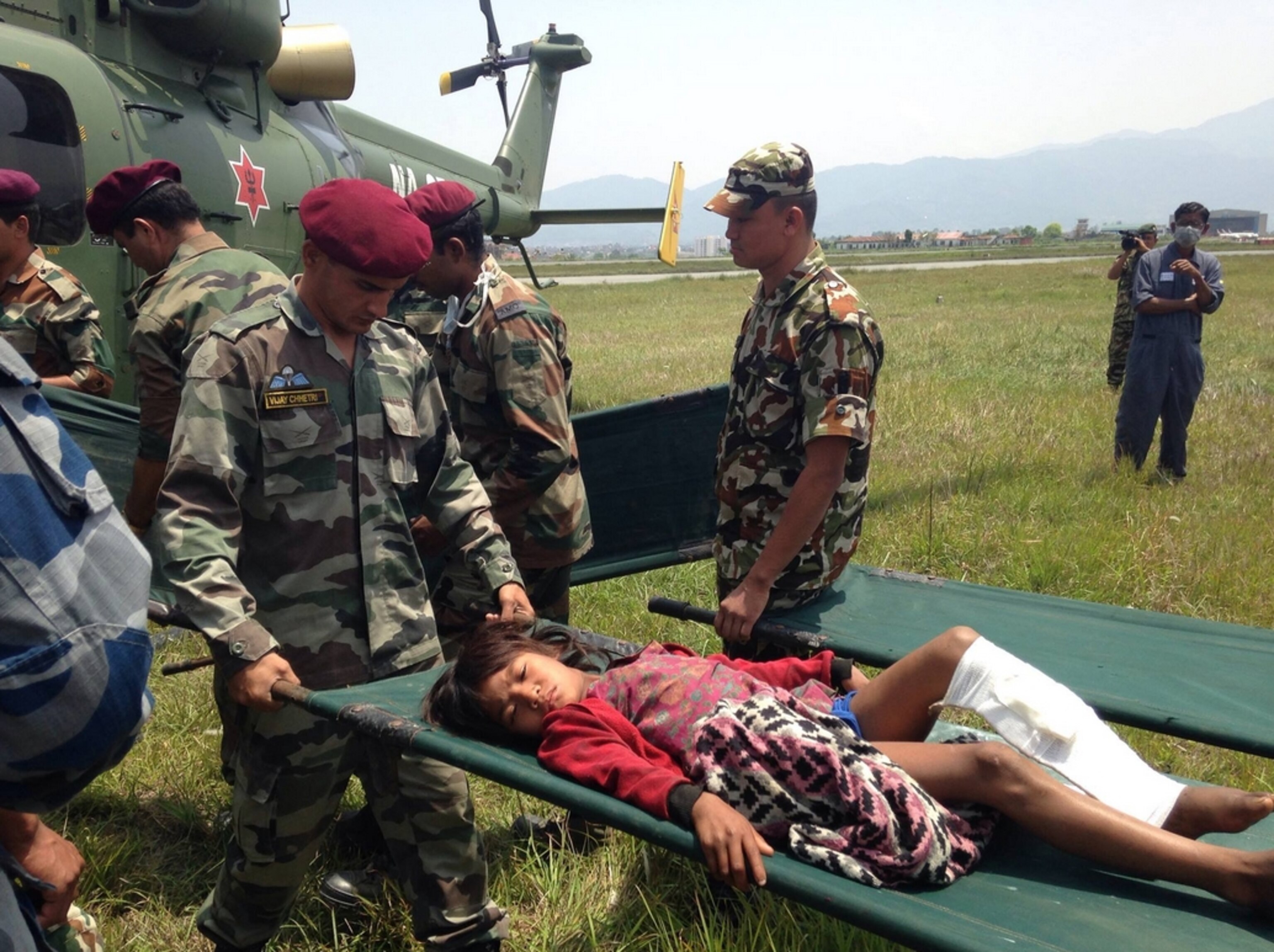 Flew to Pokhara today with a private rescue company to escort some folks back to KTM. We were able to wander the air strip for a while and watched a helicopter unload a number of patients then take off loaded with supplies; Photograph by Libby Sauter