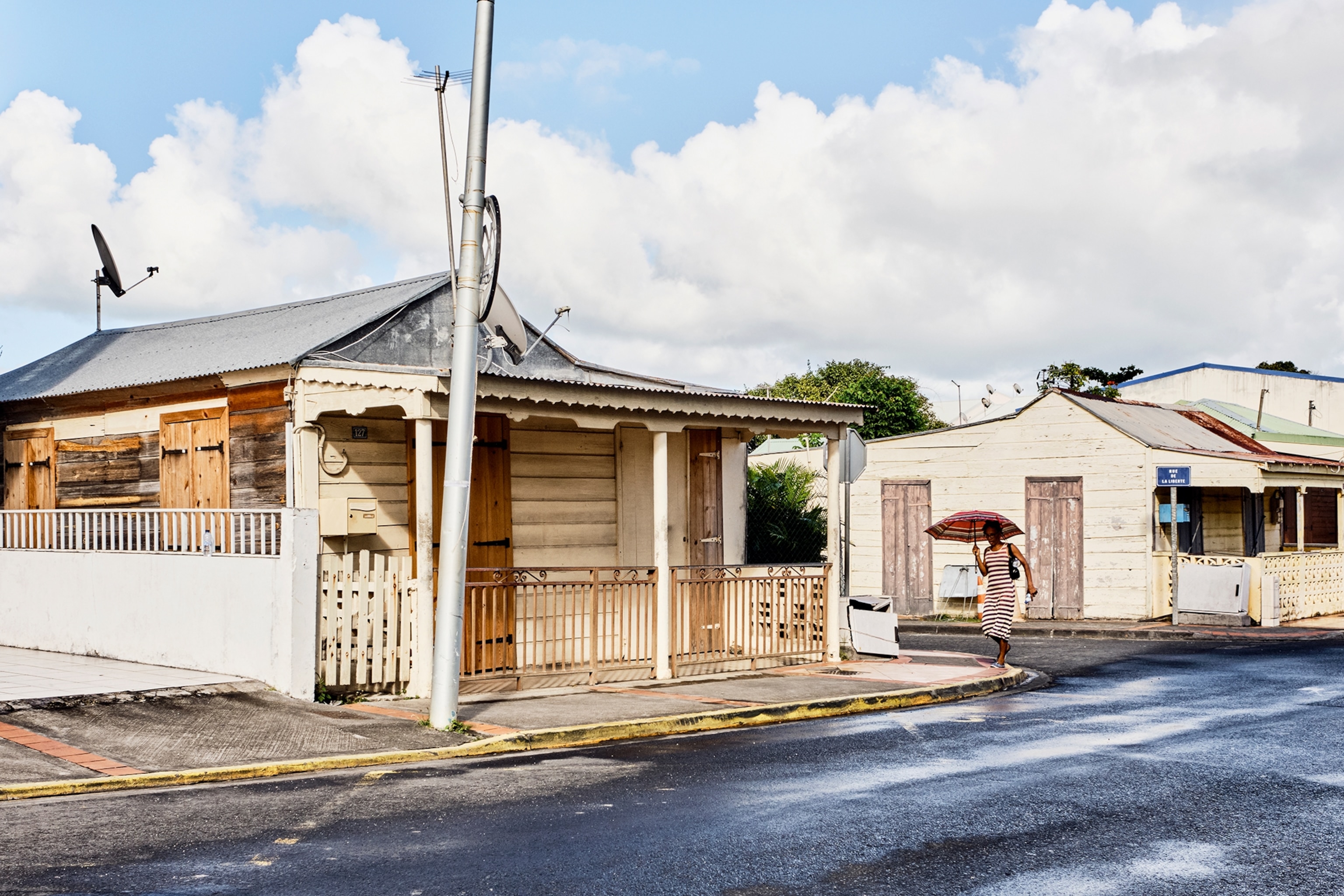 A streetview of a calm residential street with bungalow-style houses.