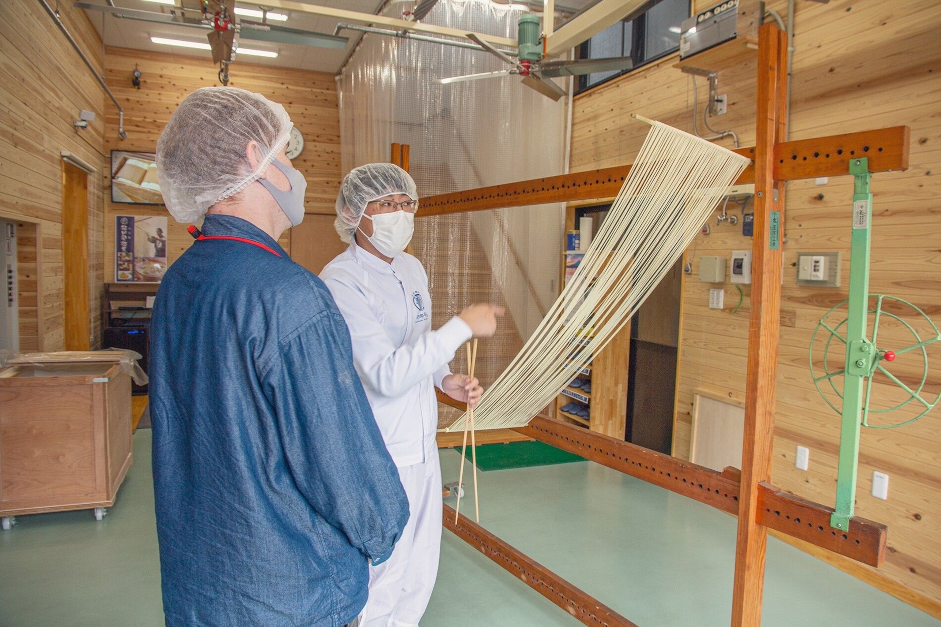 People hand-producing somen noodles.