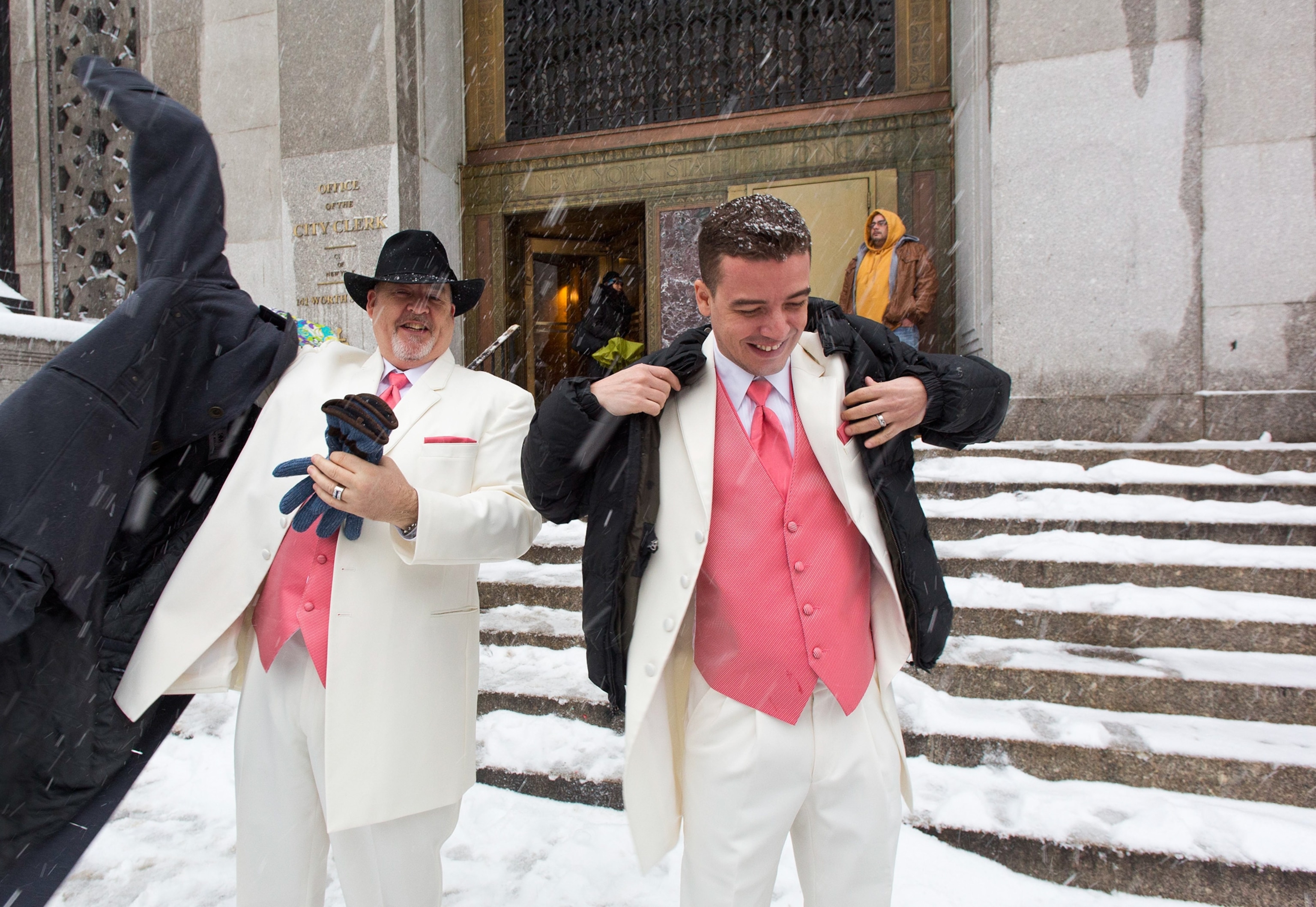 A man braces his umbrella while walking through the snow in NY City.