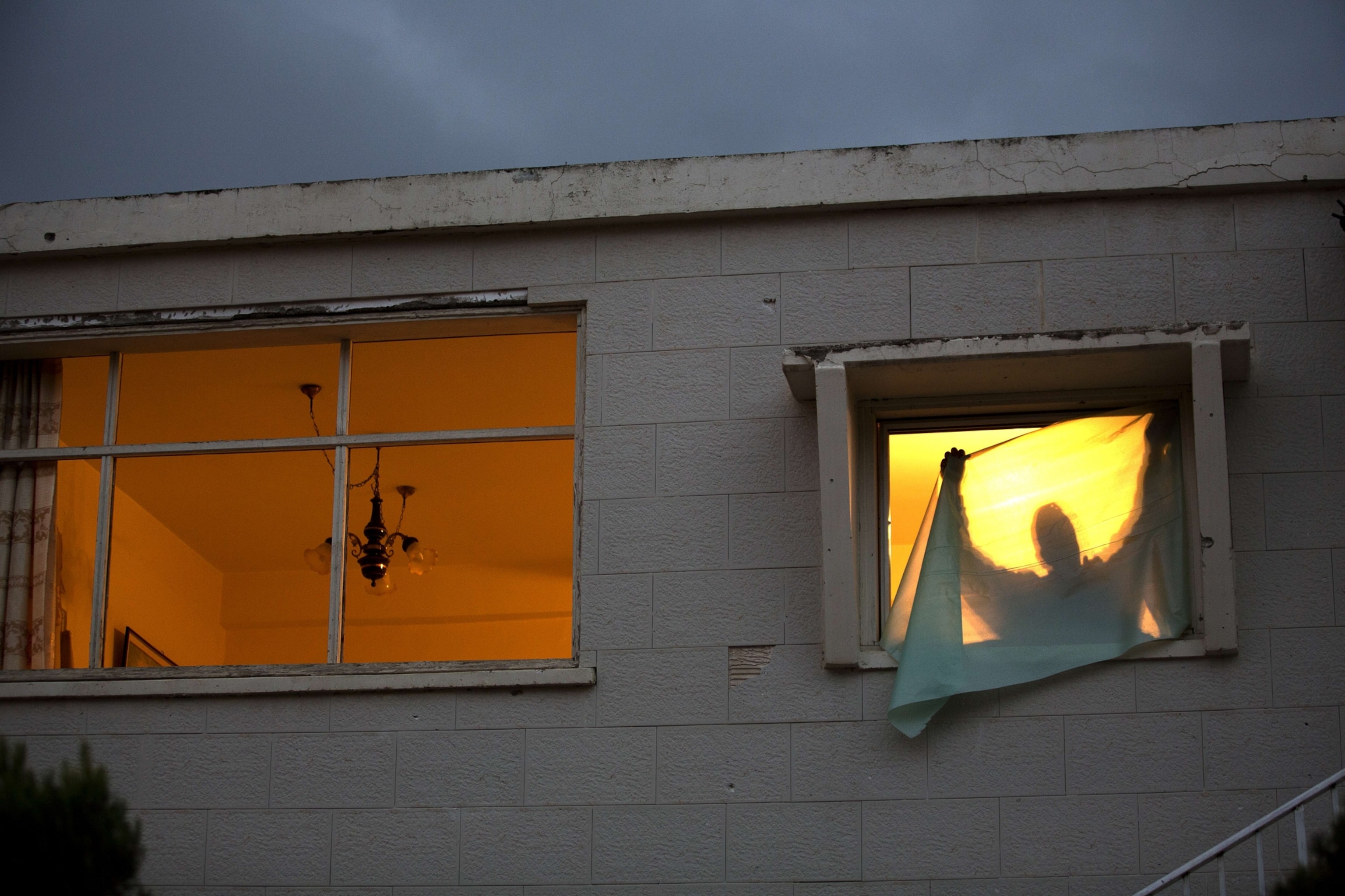 an Israeli man at a window, Netivot, Israel