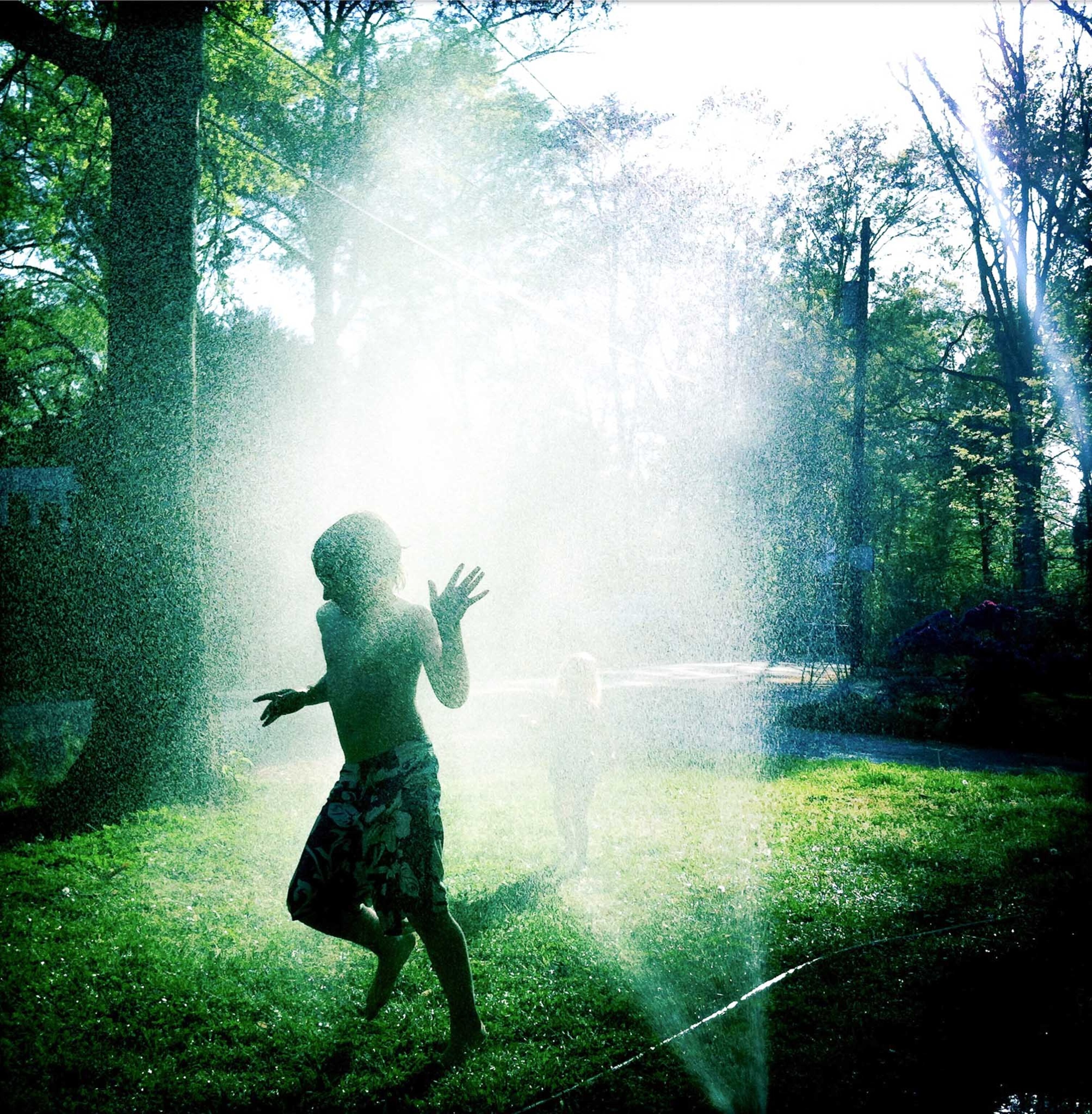 Kids playing in front yard sprinkler - Cabin John, MD