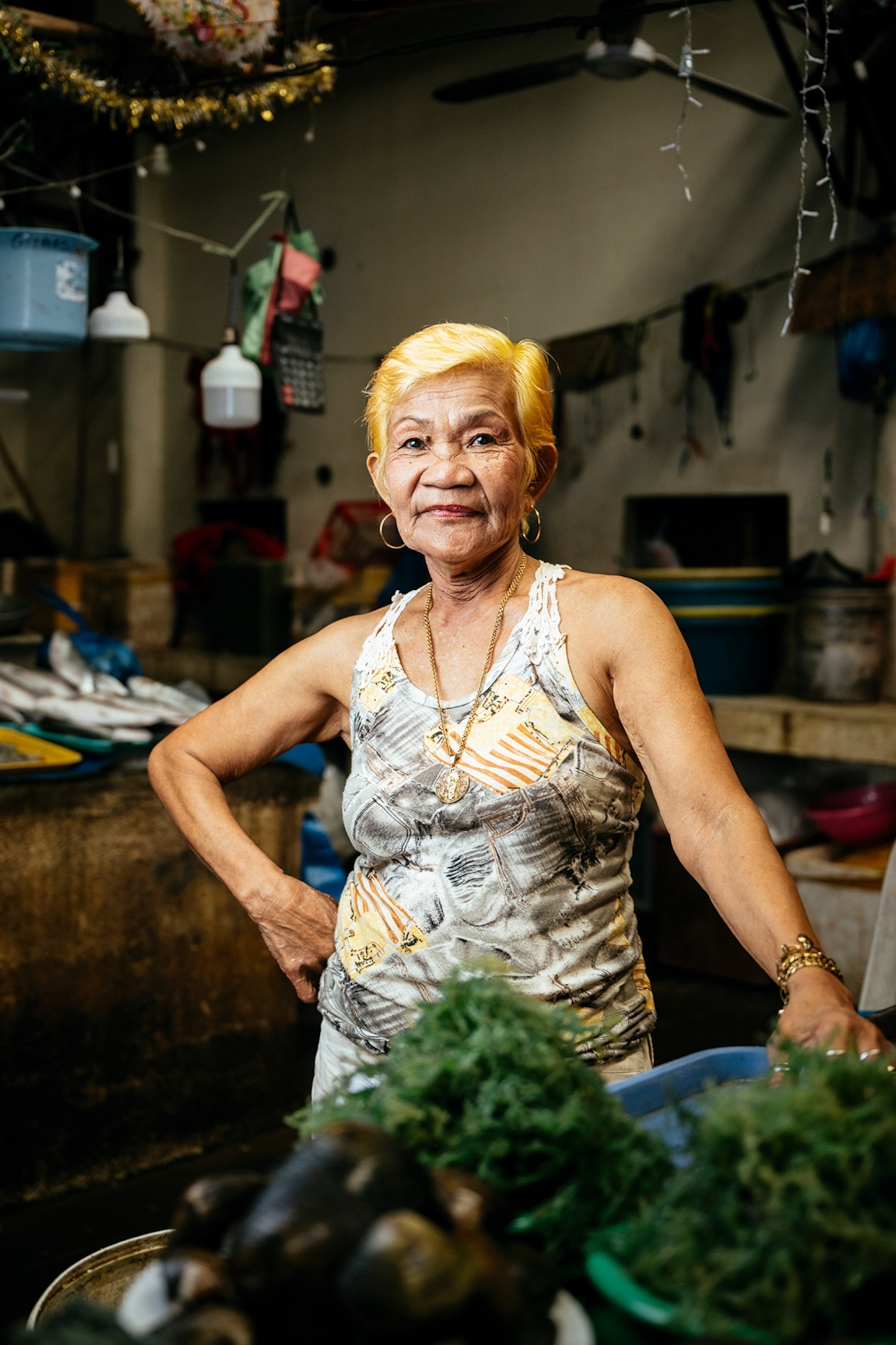 The portrait of a middle-aged local woman behind the counter of her street stall.