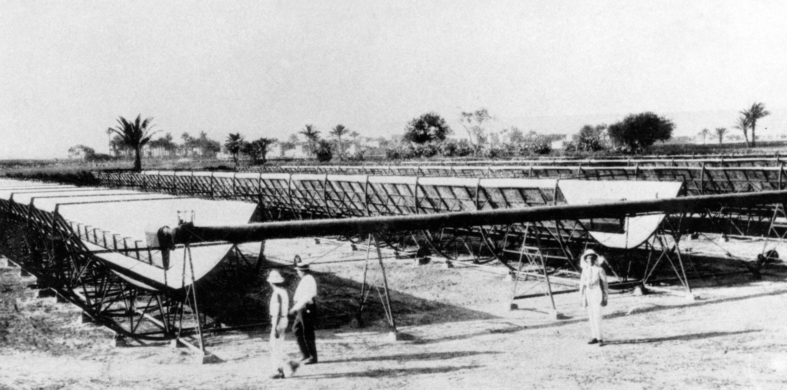 Workers inspect the first commercial solar power plant