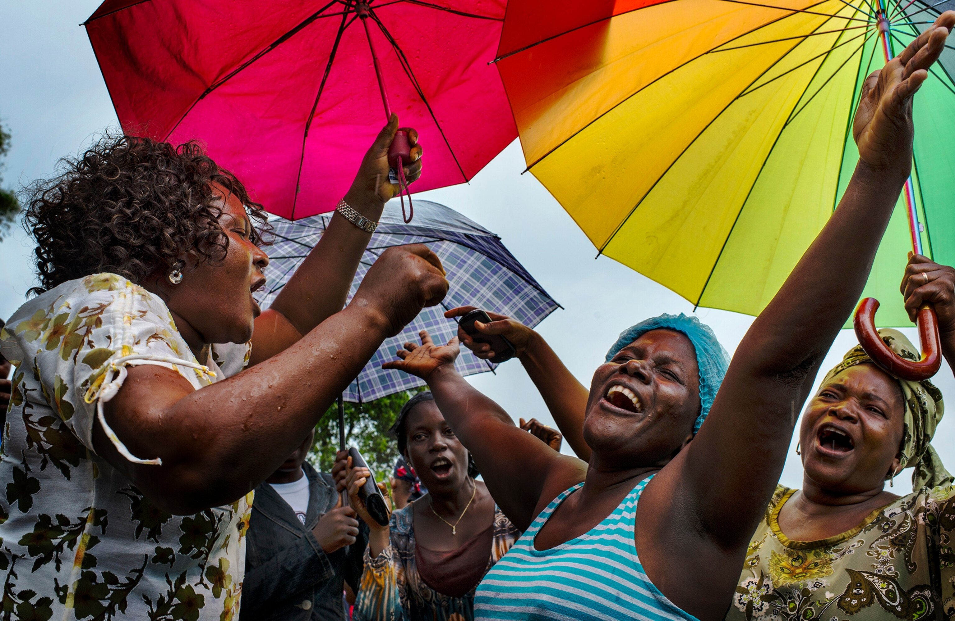 Klubo Mulbah, (center in blue) a nurse who was infected with Ebola by a patient celebrates among friends and family on Tuesday September 24, 2014 in Monrovia, Liberia.