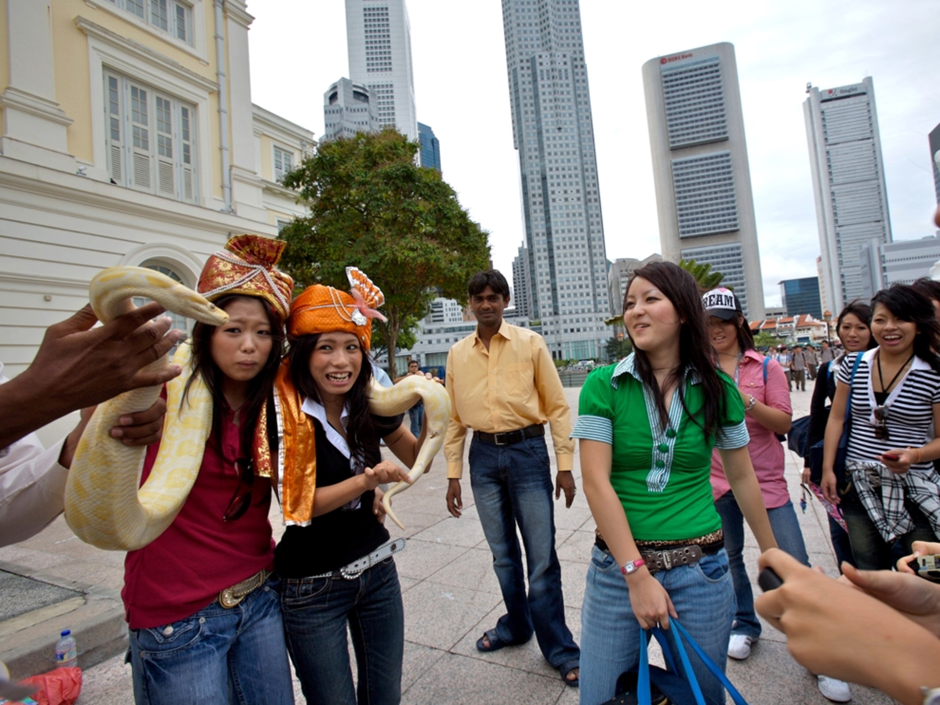 Tourists pose with a python