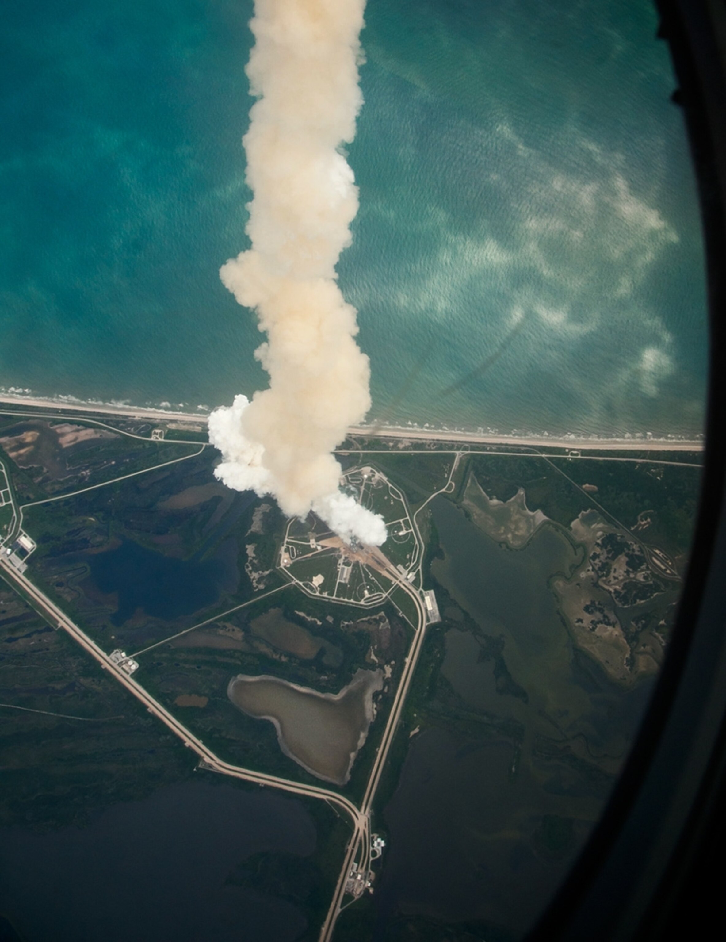 the space shuttle launch plume as seen from a NASA plane