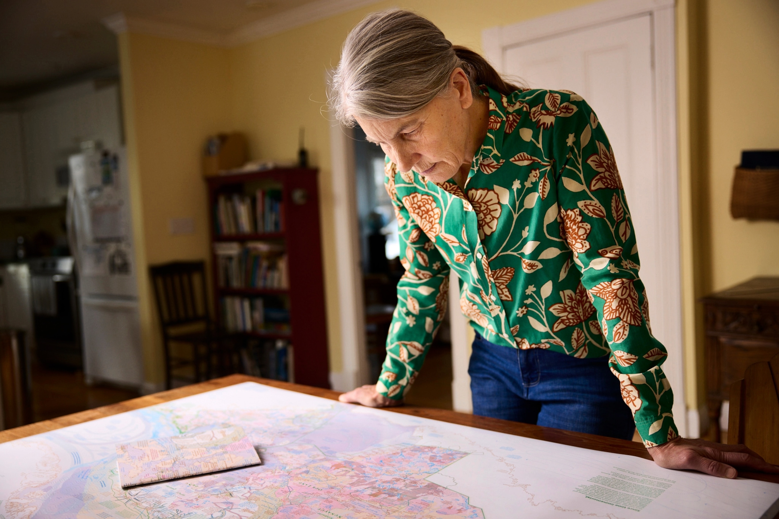 A woman looks down at a map