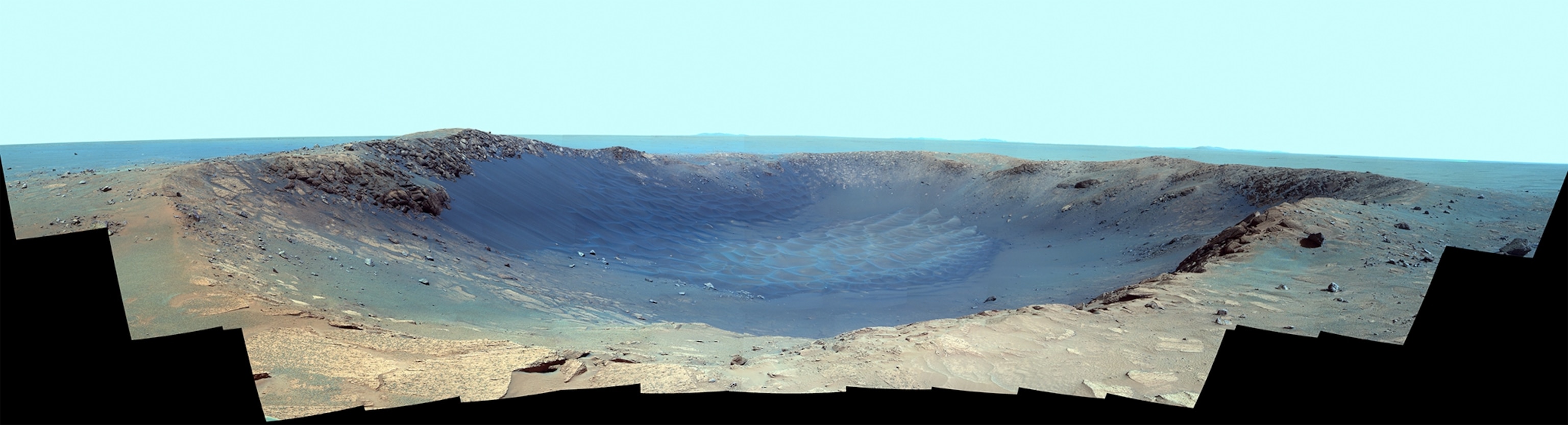 NASA's Mars Exploration Rover Opportunity captured this view of "Burns Cliff" after driving right to the base of this southeastern portion of the inner wall of "Endurance Crater." The view combines frames taken by Opportunity's panoramic camera between the rover's 287th and 294th martian days (Nov. 13 to 20, 2004).