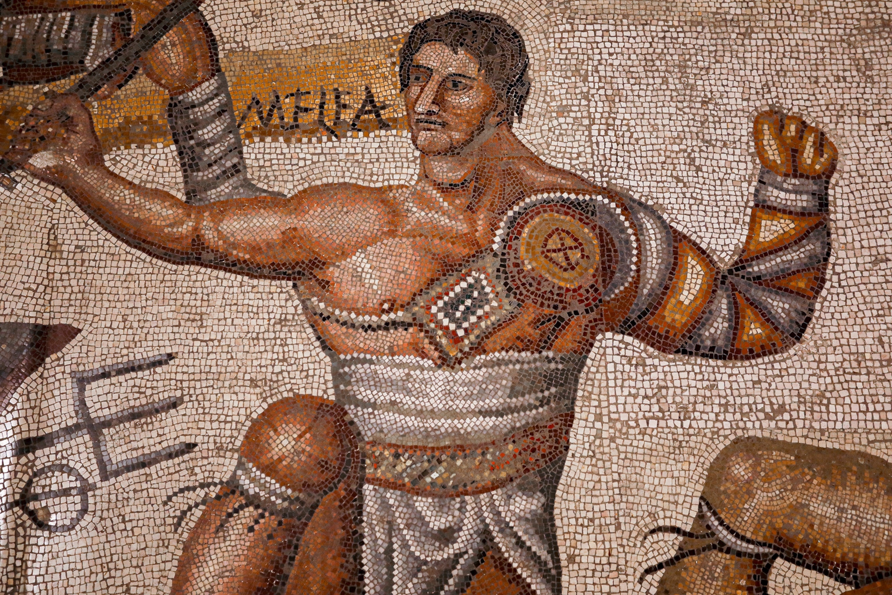 ancient mosaic depicting a muscular man.