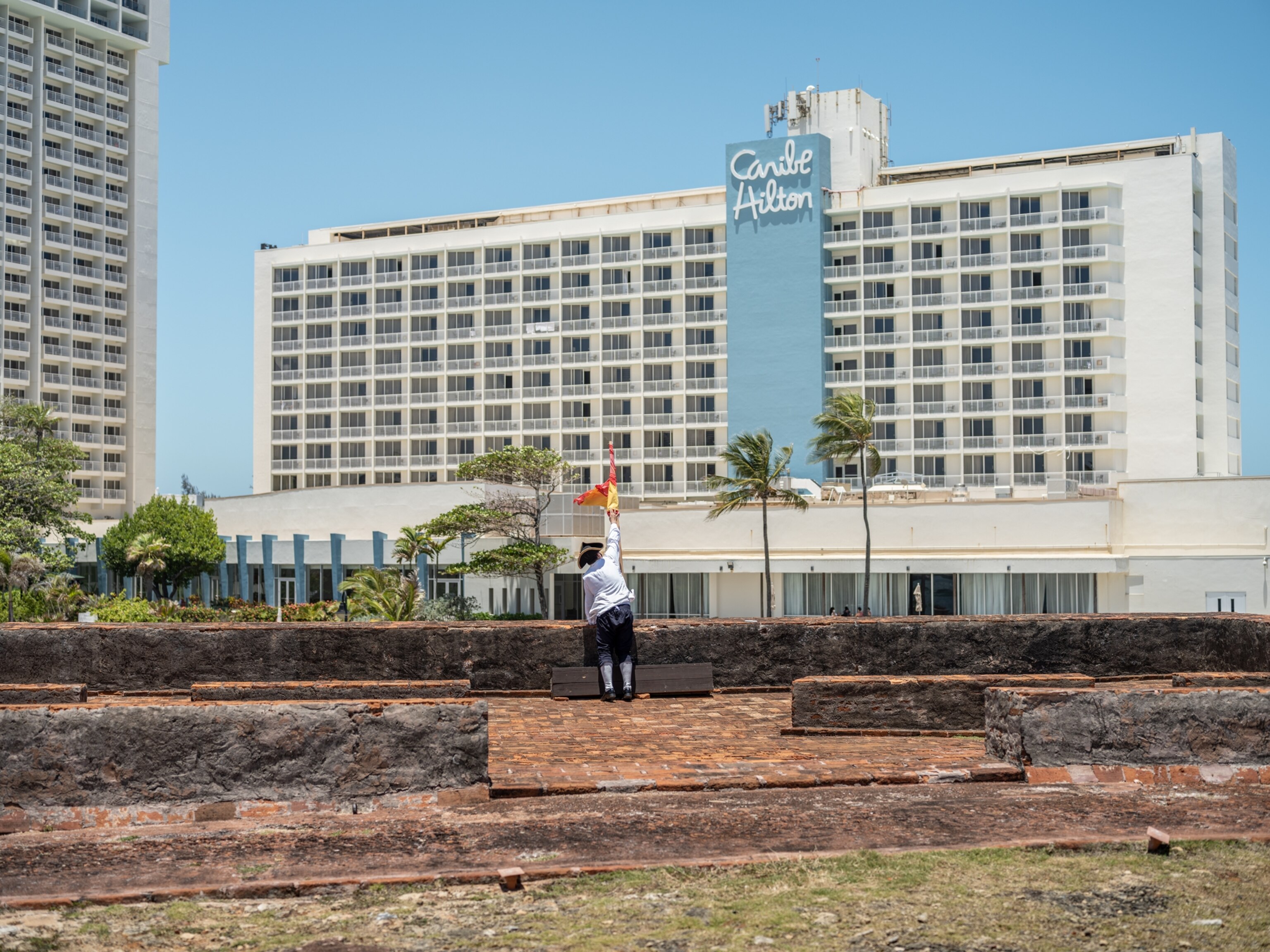 Reenactor reaching to the flag.