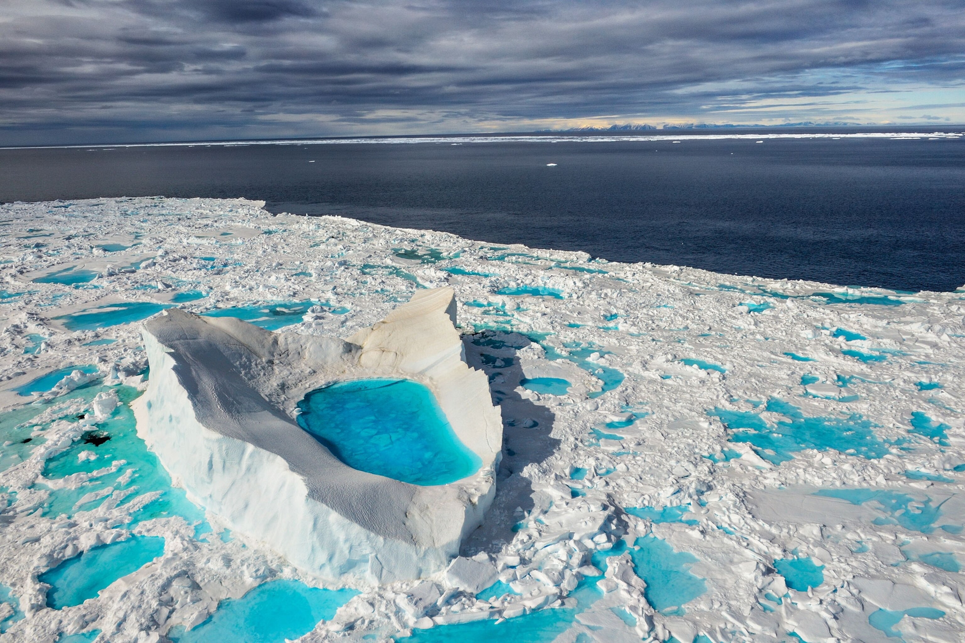 an iceberg with a meltwater pool in Navy Board Inlet, Canada