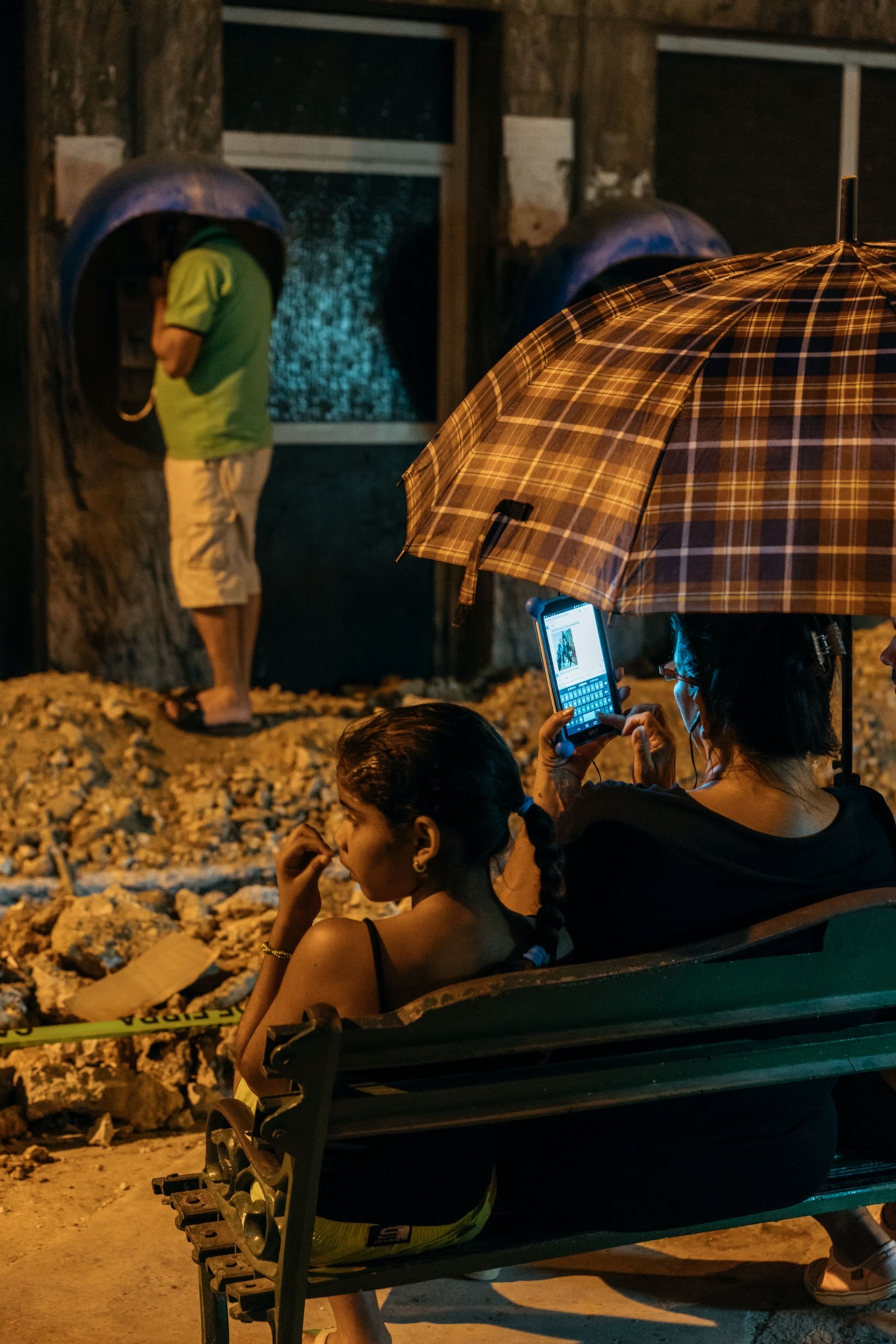 a family checking their phones in Havana, Cuba