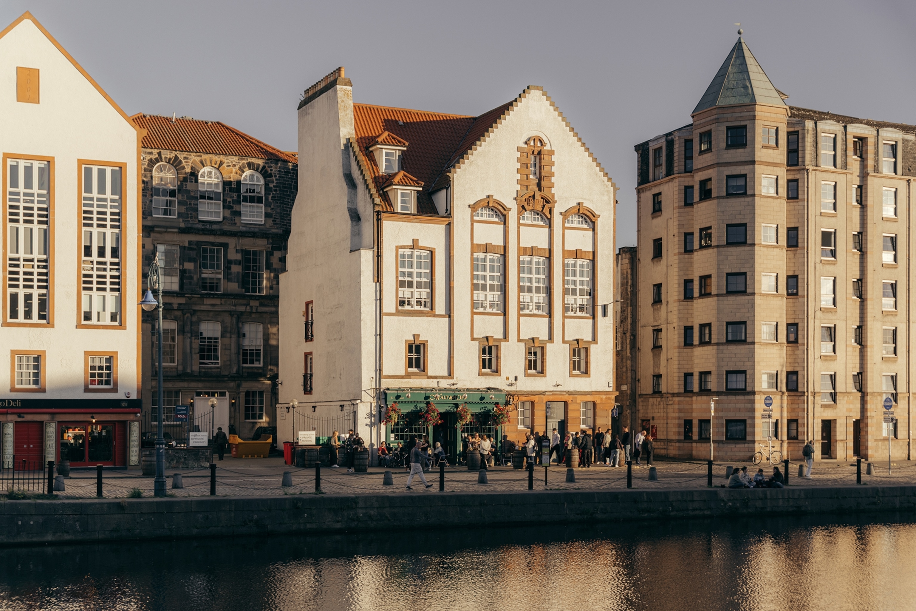 A waterfront city line with old and ornate brick buildings.