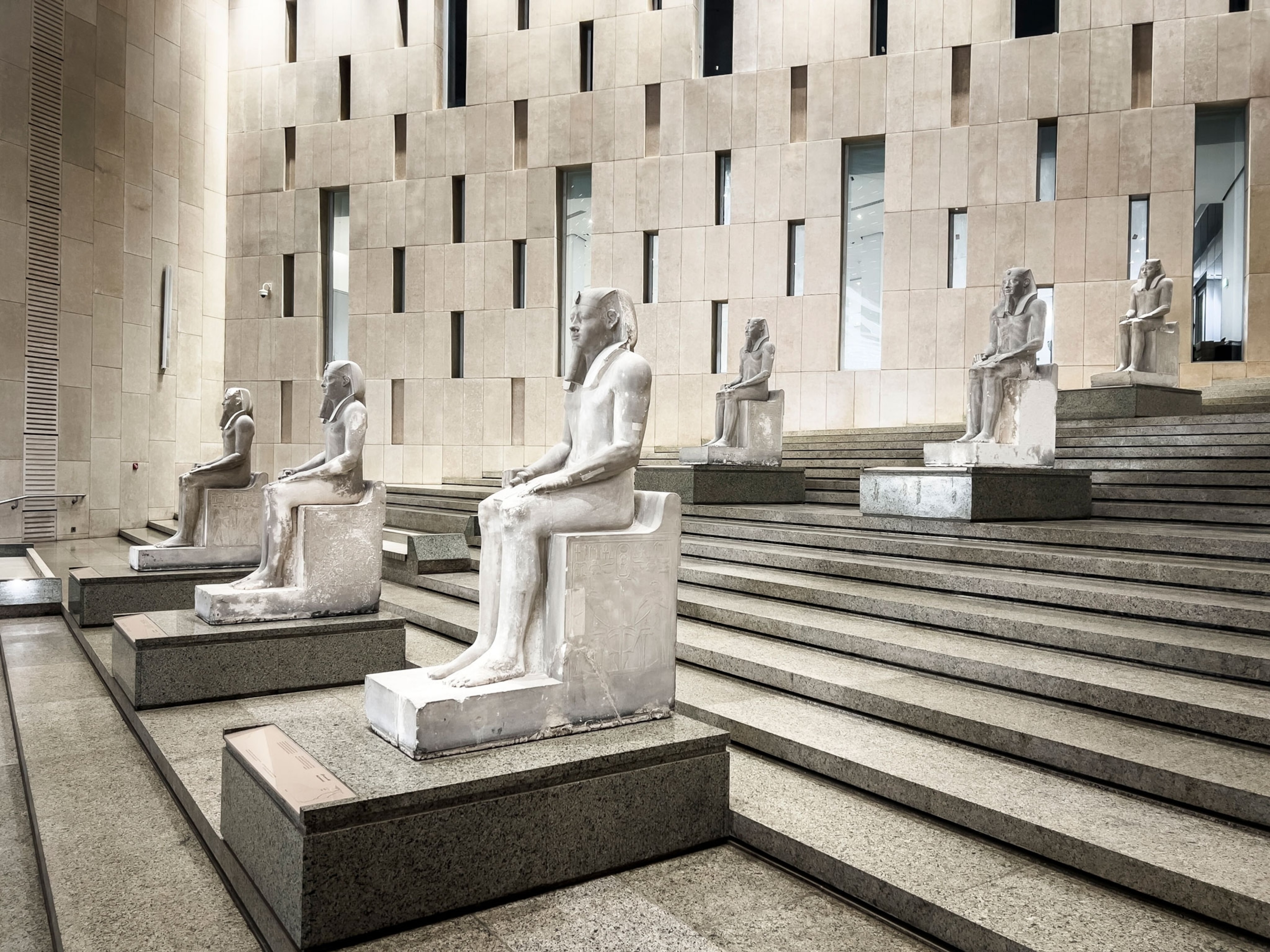 Decorated with statues, a beautiful staircase leads to the entrance to the rooms at the Grand Egyptian Museum
