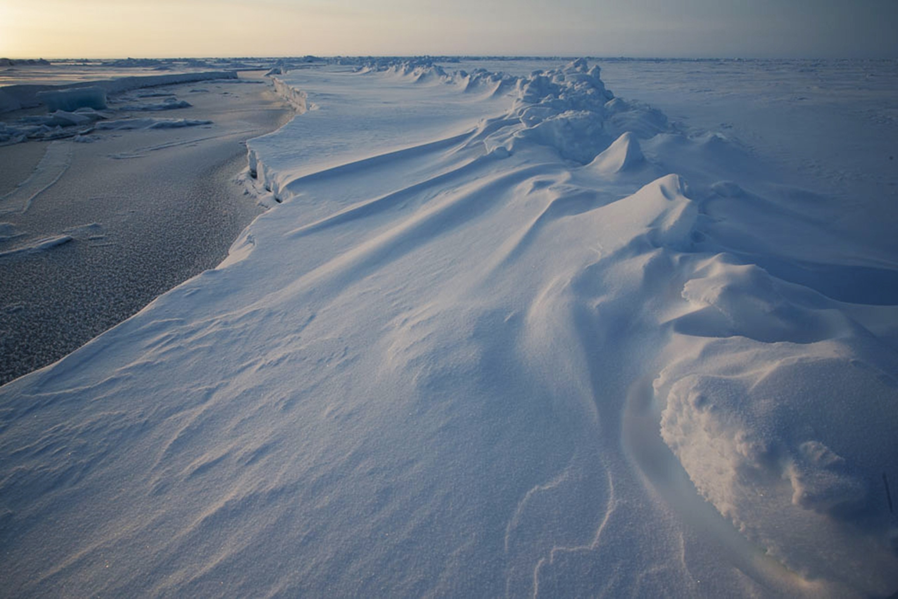 the edge of an ice floe showing a lead between the floes that has refrozen