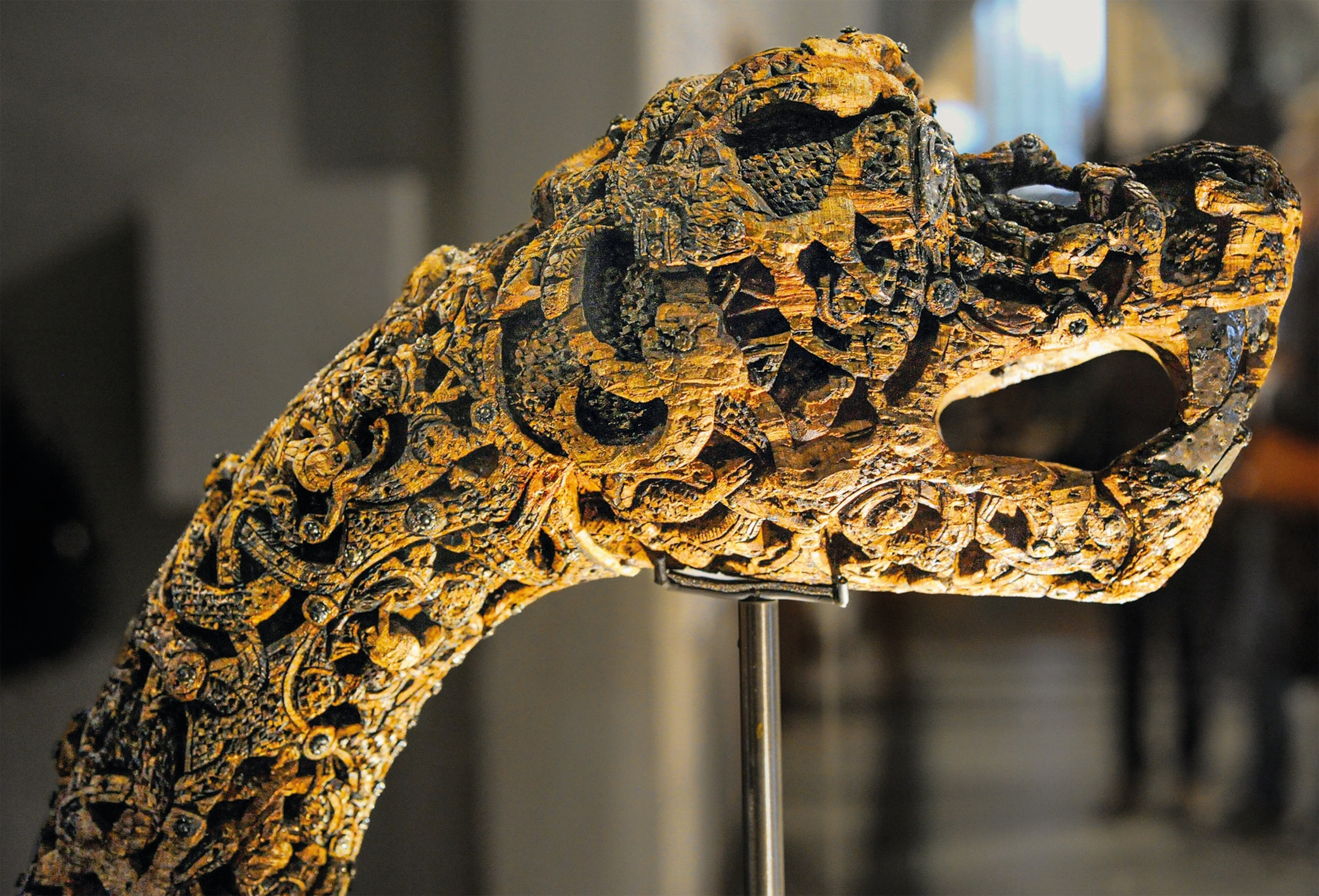 A carved animal head mounted on a pole is pictured.