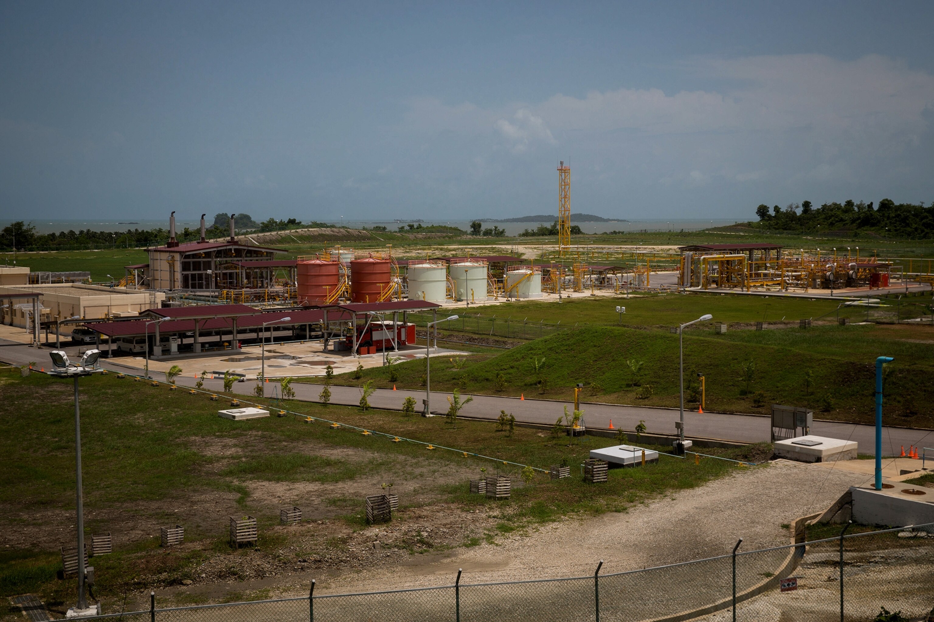 a boatman steering through a mangrove swamp near the start of a 1,500 mile oil pipeline from the Bay of Bengal to China's Yunan province.