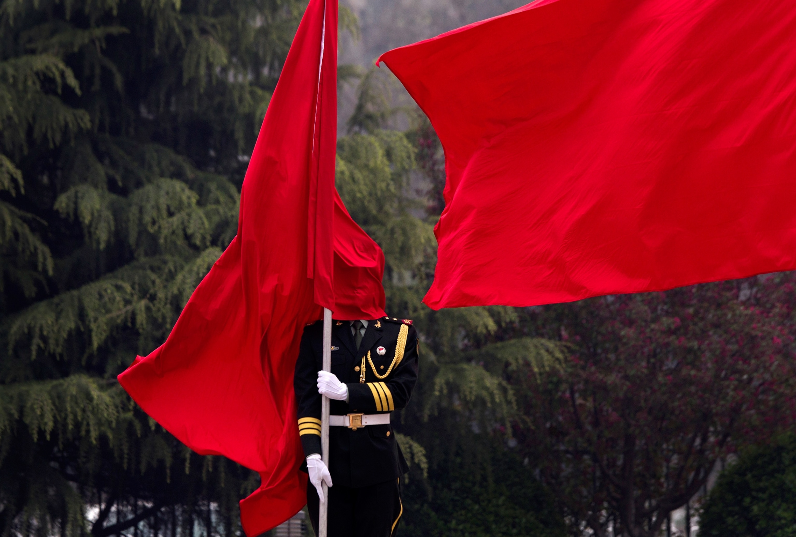 a flag covering a guard's face in Beijing, China