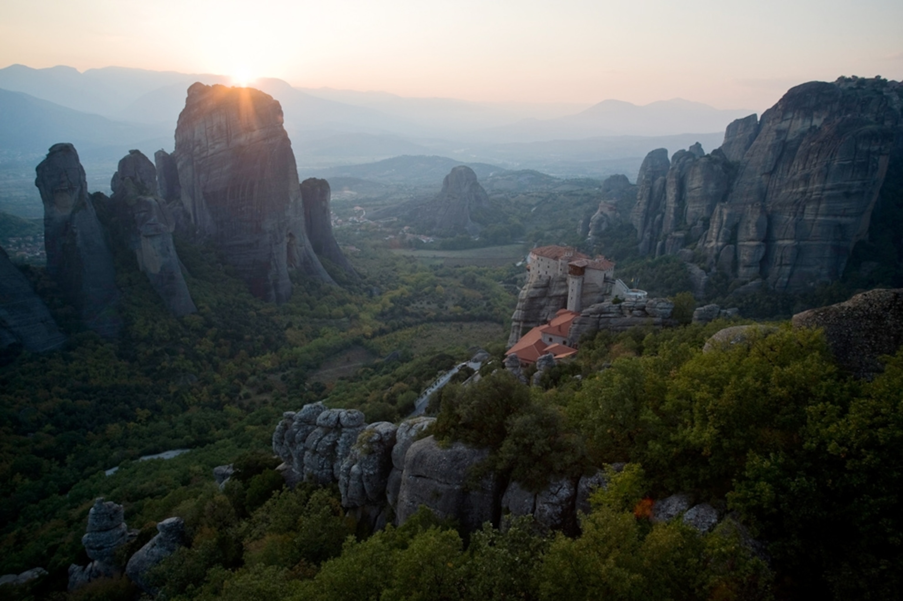 A monastery on a cliff overlooking a valley
