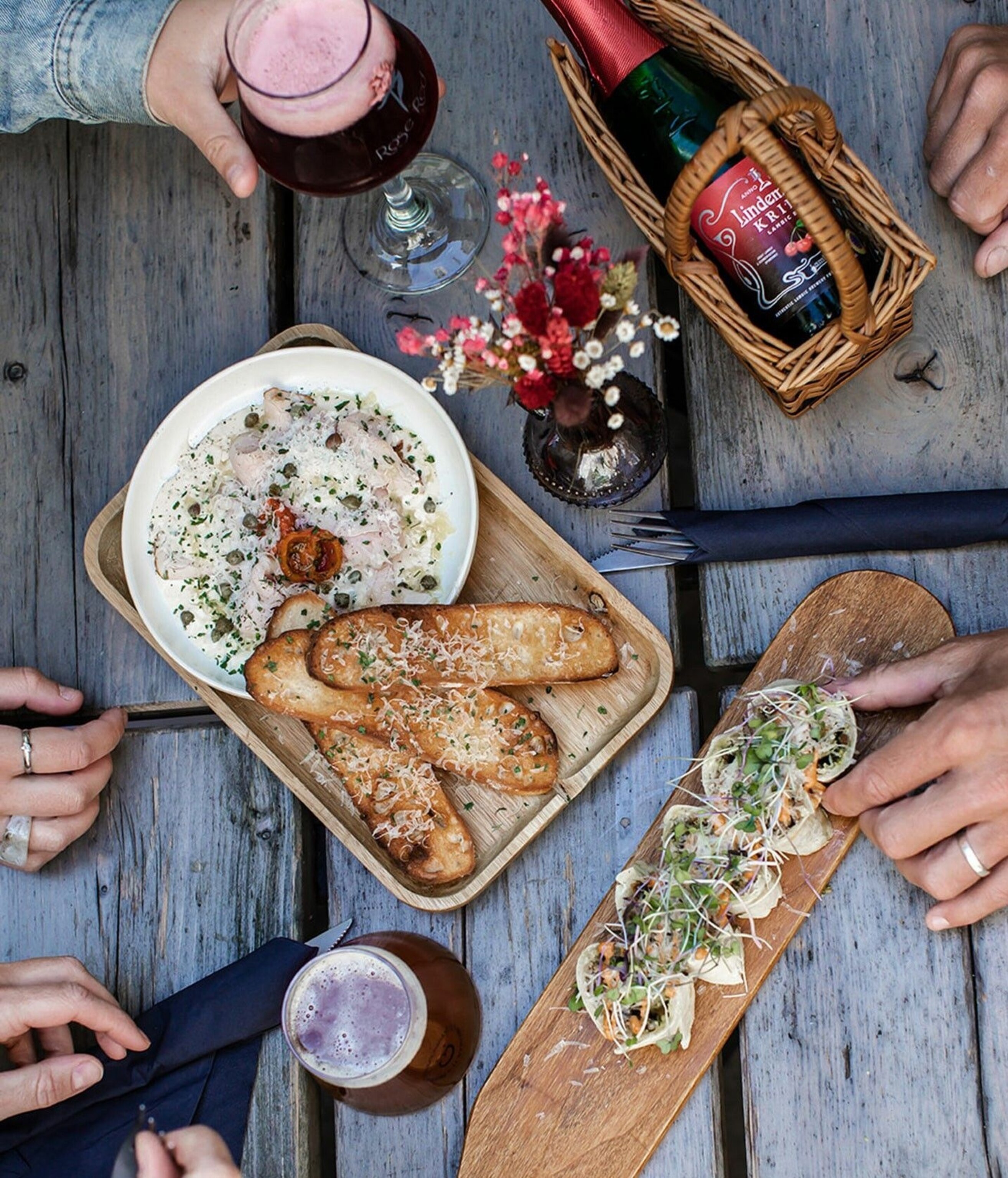 An array of small plates served on wooden boards.