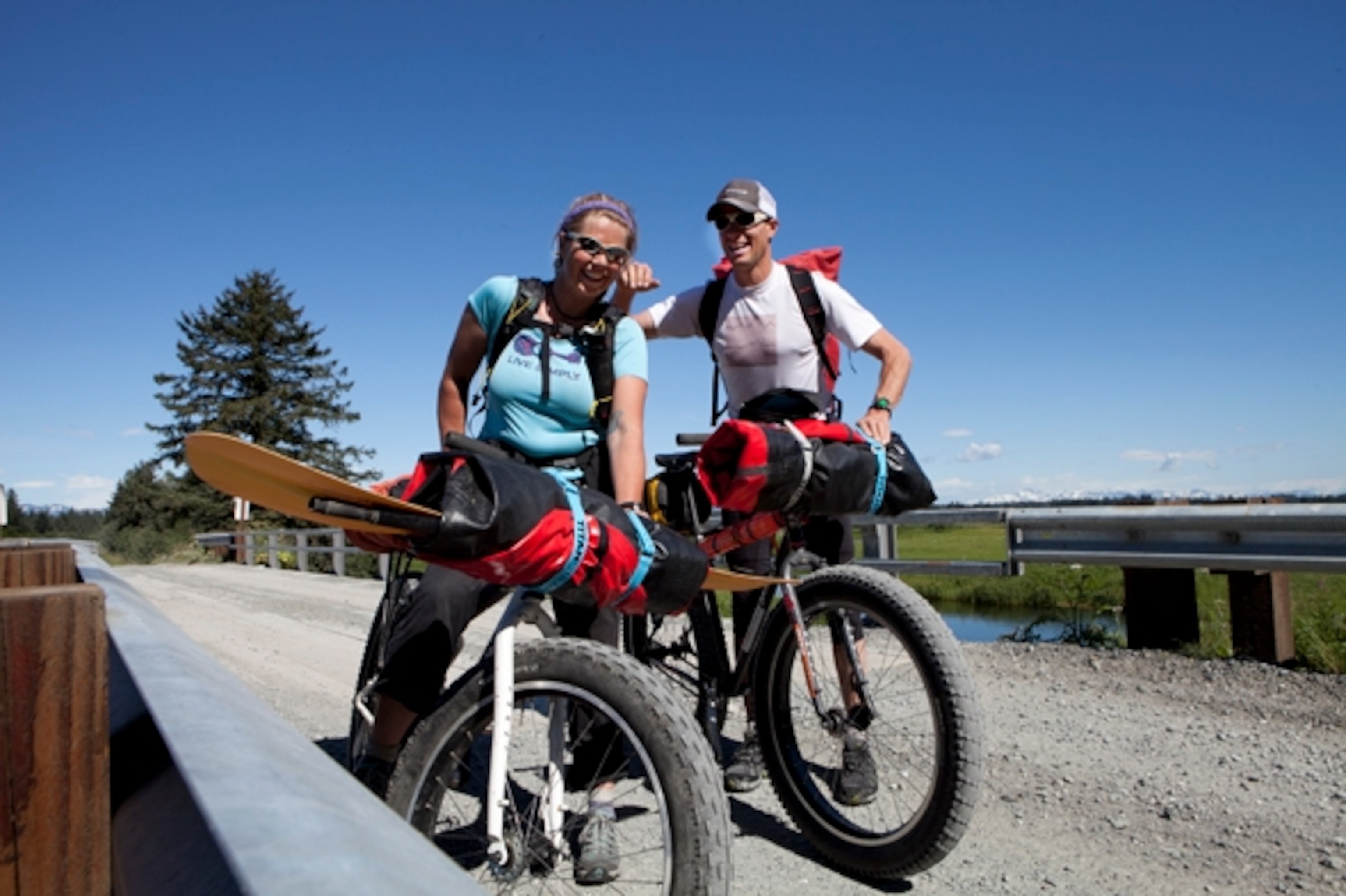 Iris and I took a break on the outskirts of Yakutat, as we pedaled along a dirt road that lead to the coast. Open meadows provided commanding views of the St. Elias Range to the NW; Photograph by Cameron Lawson