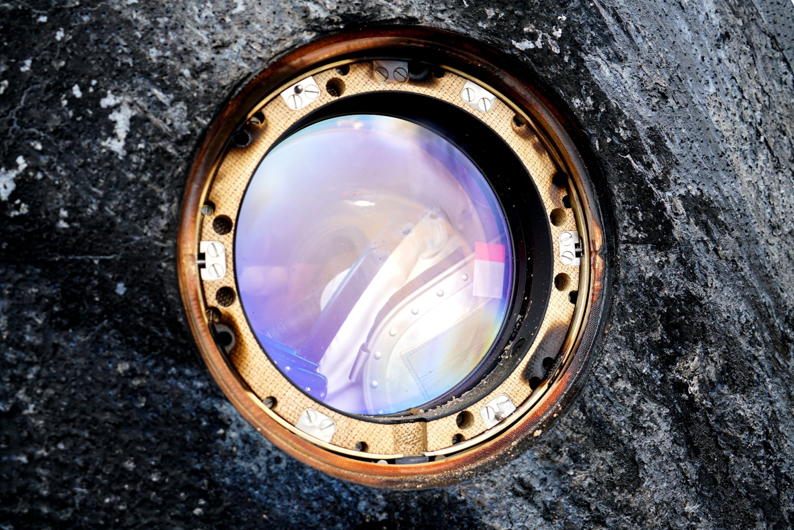 man through window of capsule