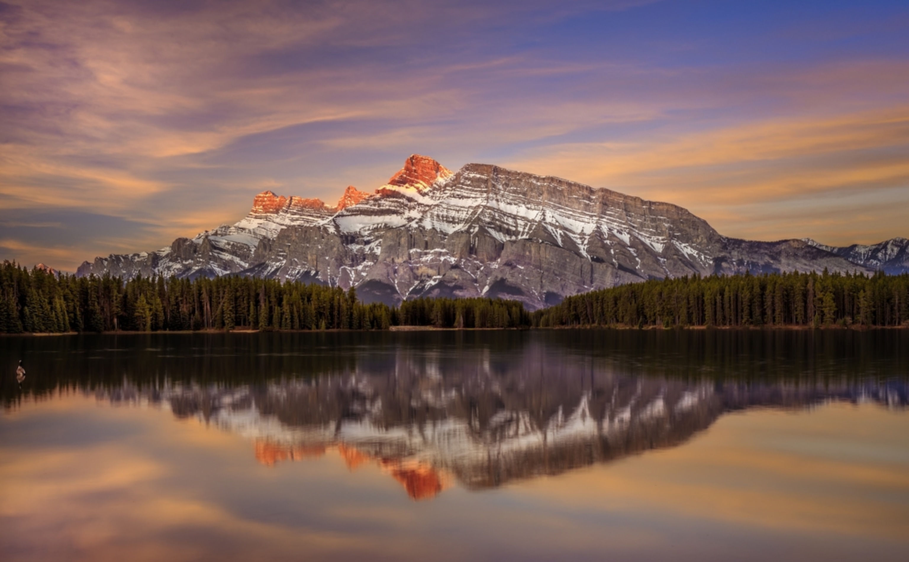 a mountain reflected in a lake in Banff National Park in Canada