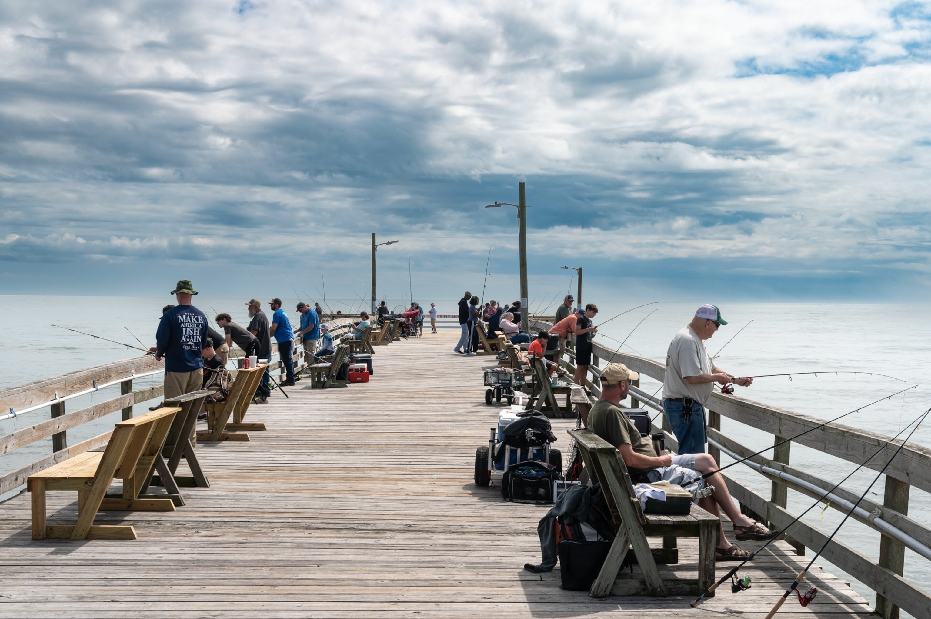 Many fishermen fishing on the Nags Head fishing pier, south of Kitty Hawk.