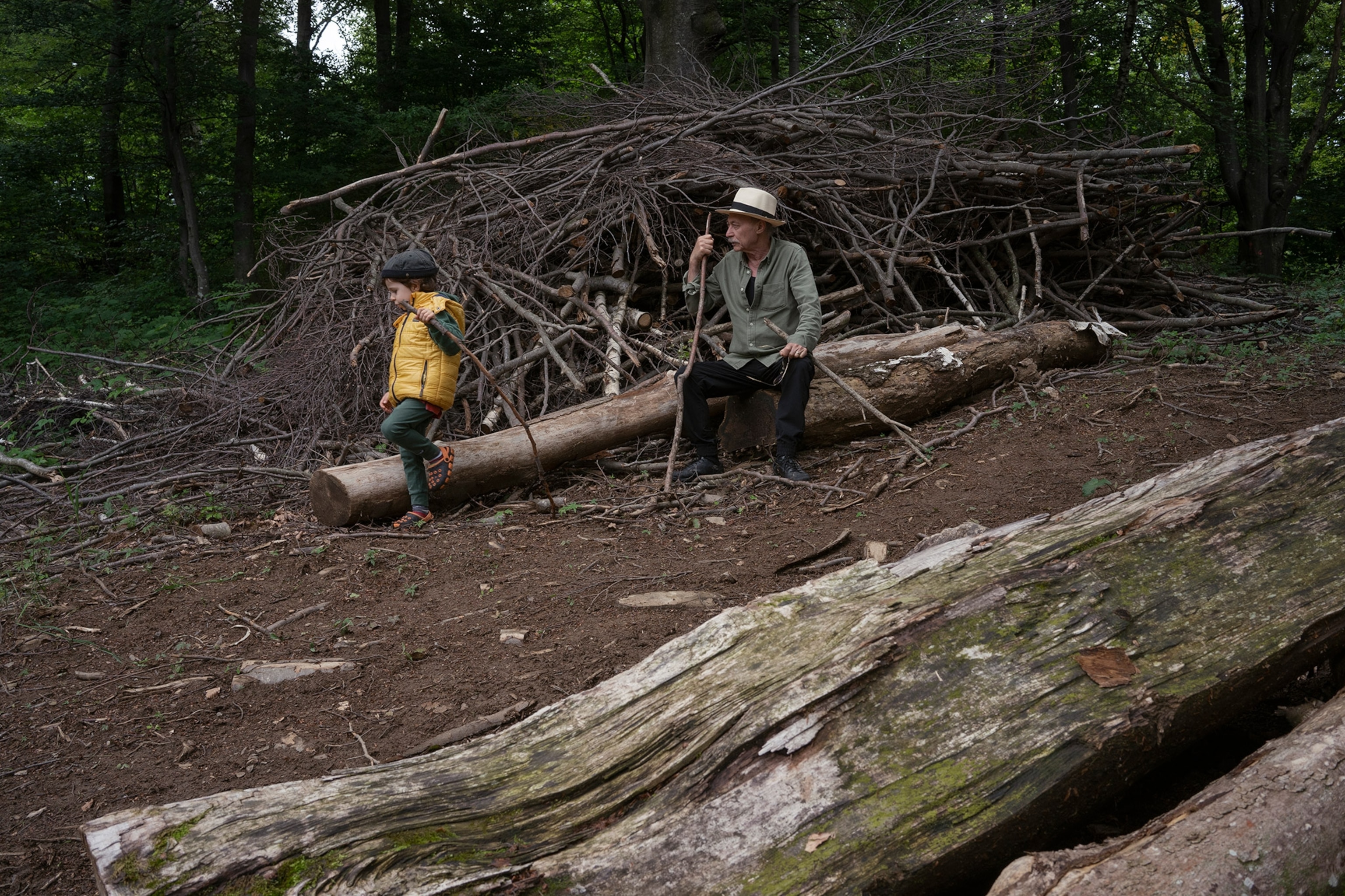 a grandfather and his son in the woods