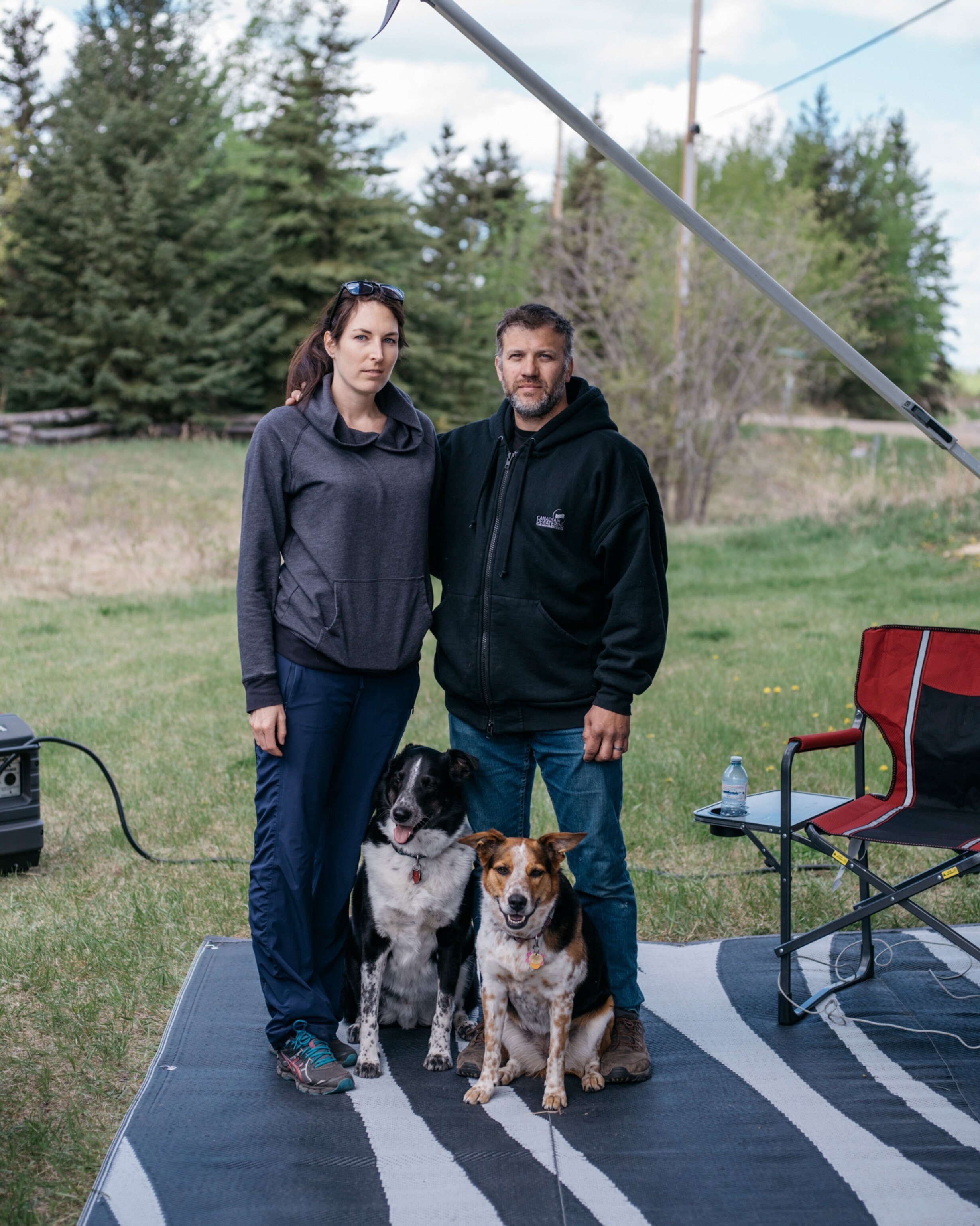 husband and wife with two dogs