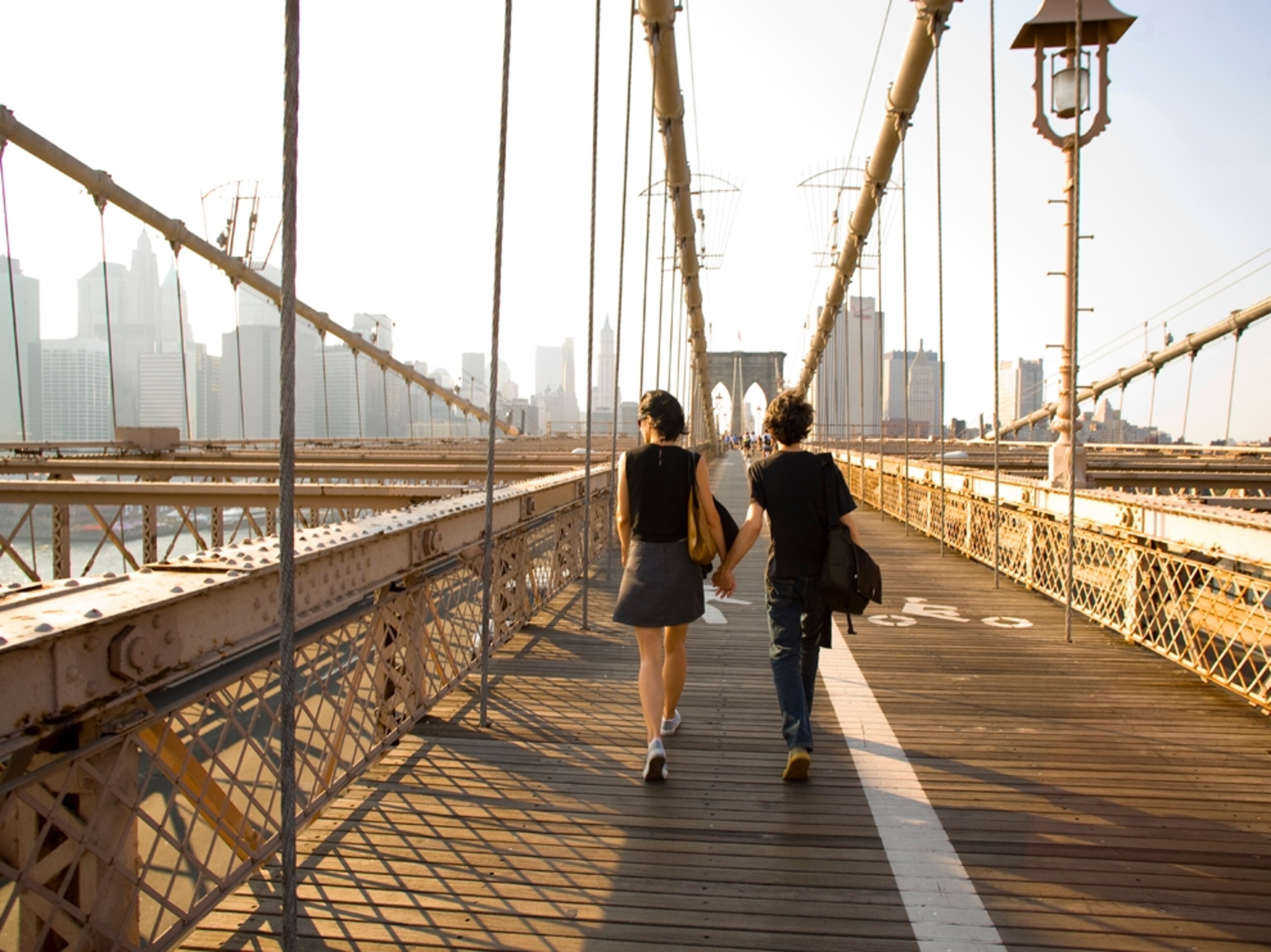 couple walking Brooklyn bridge
