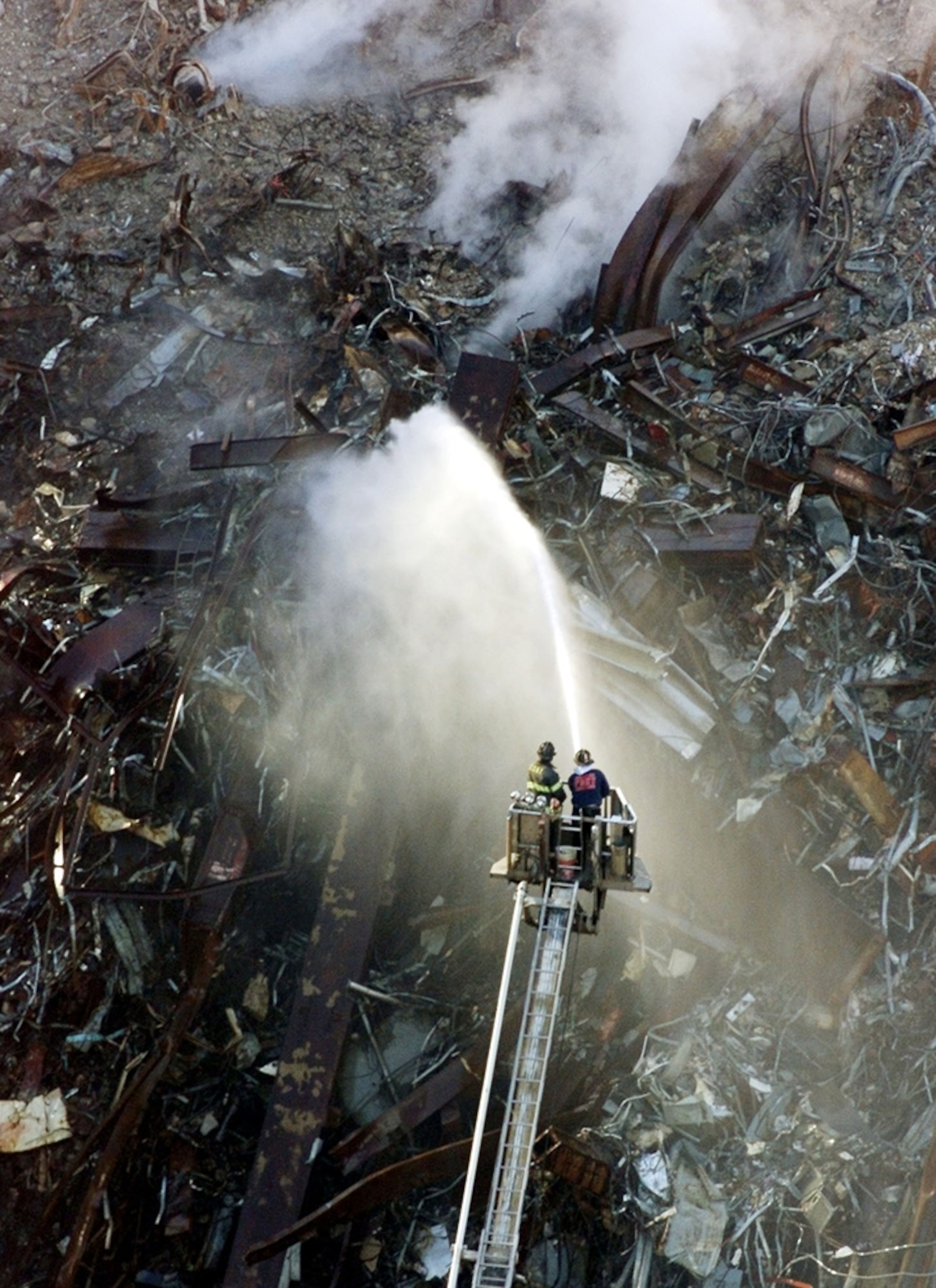 9/11 picture: Firefighters spray water of the still burning rubble at ground zero