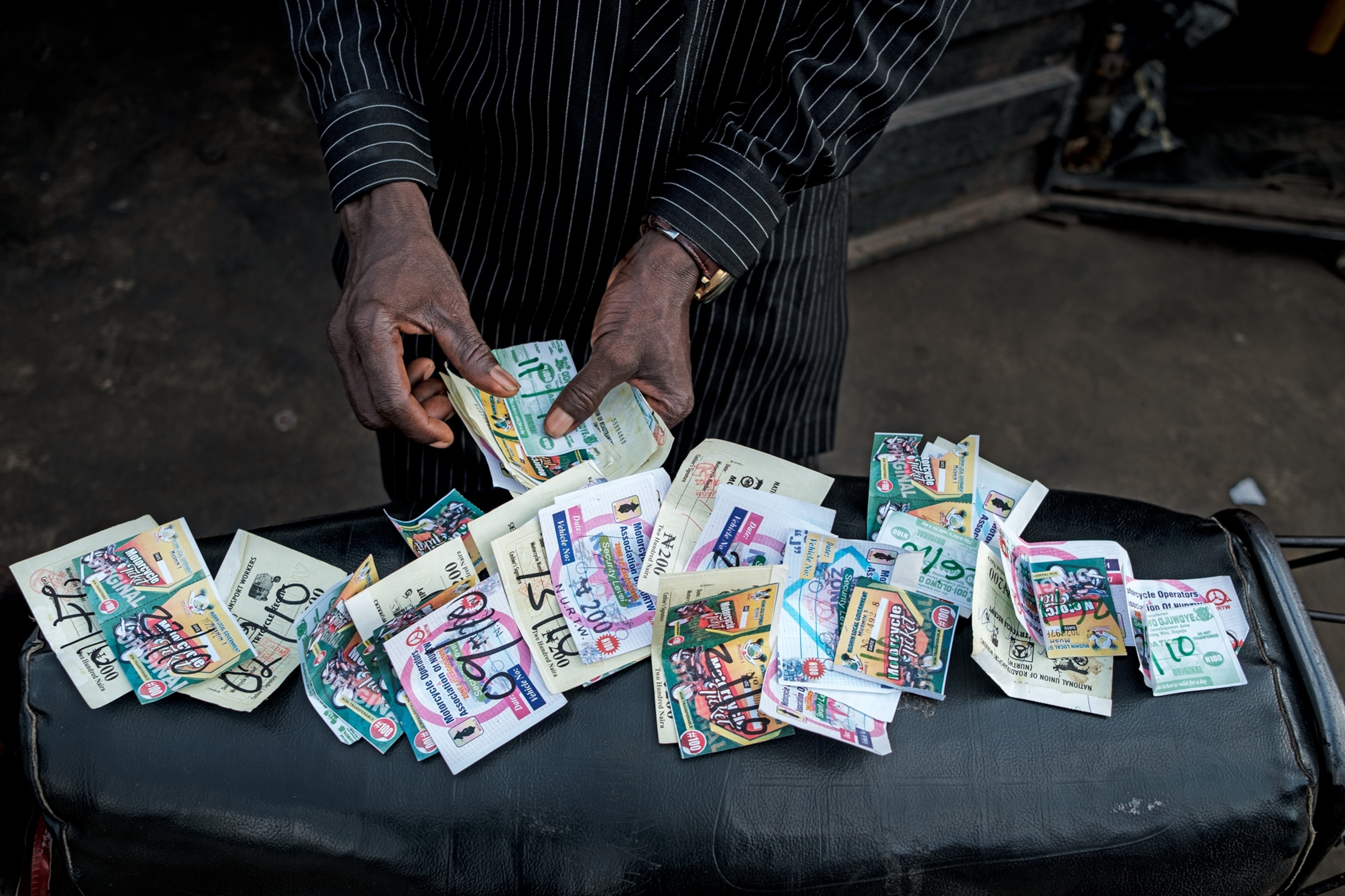 Hand showing colorful paper tickets.