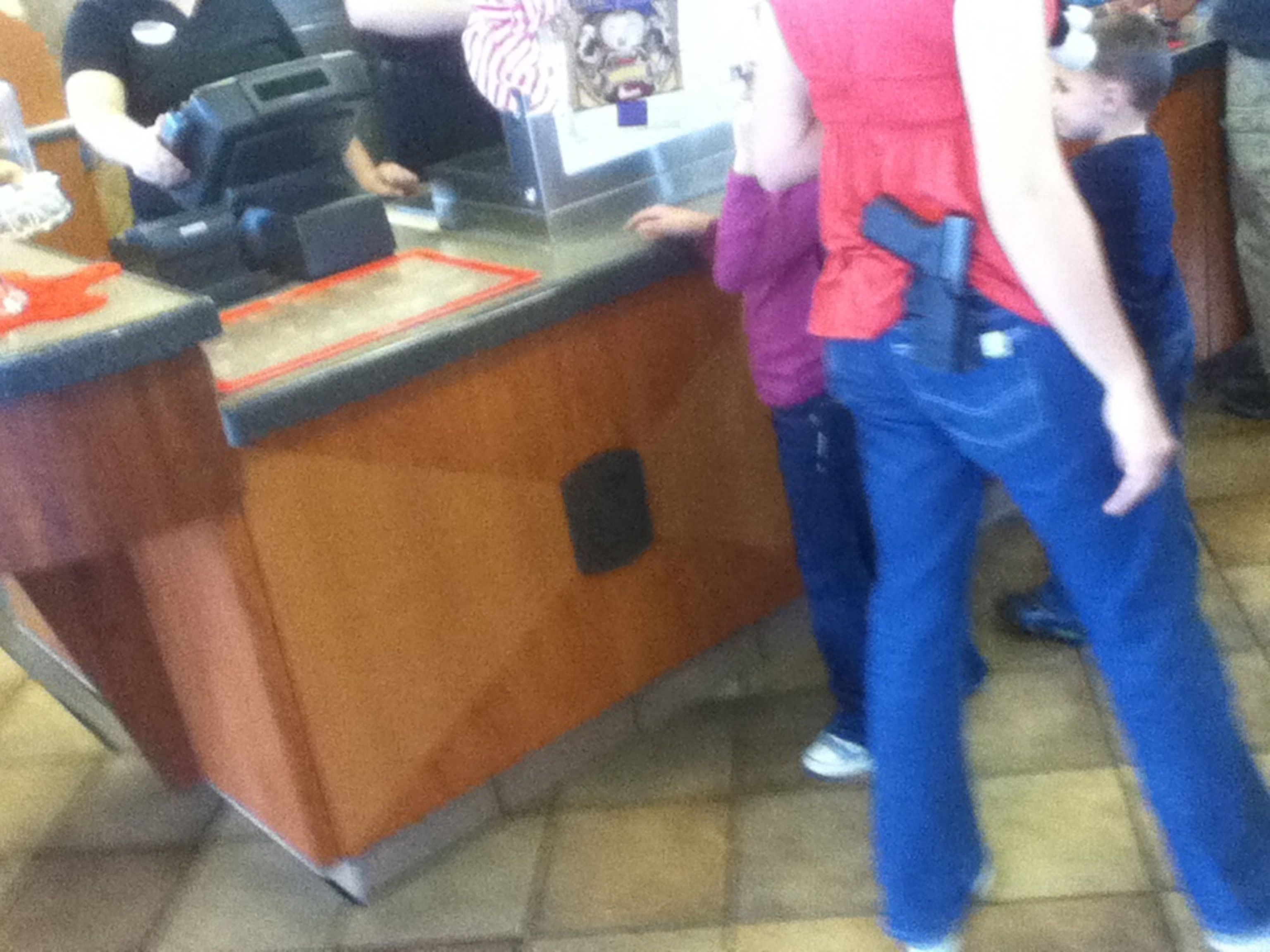 a woman carrying a gun in Chick-Fil-A