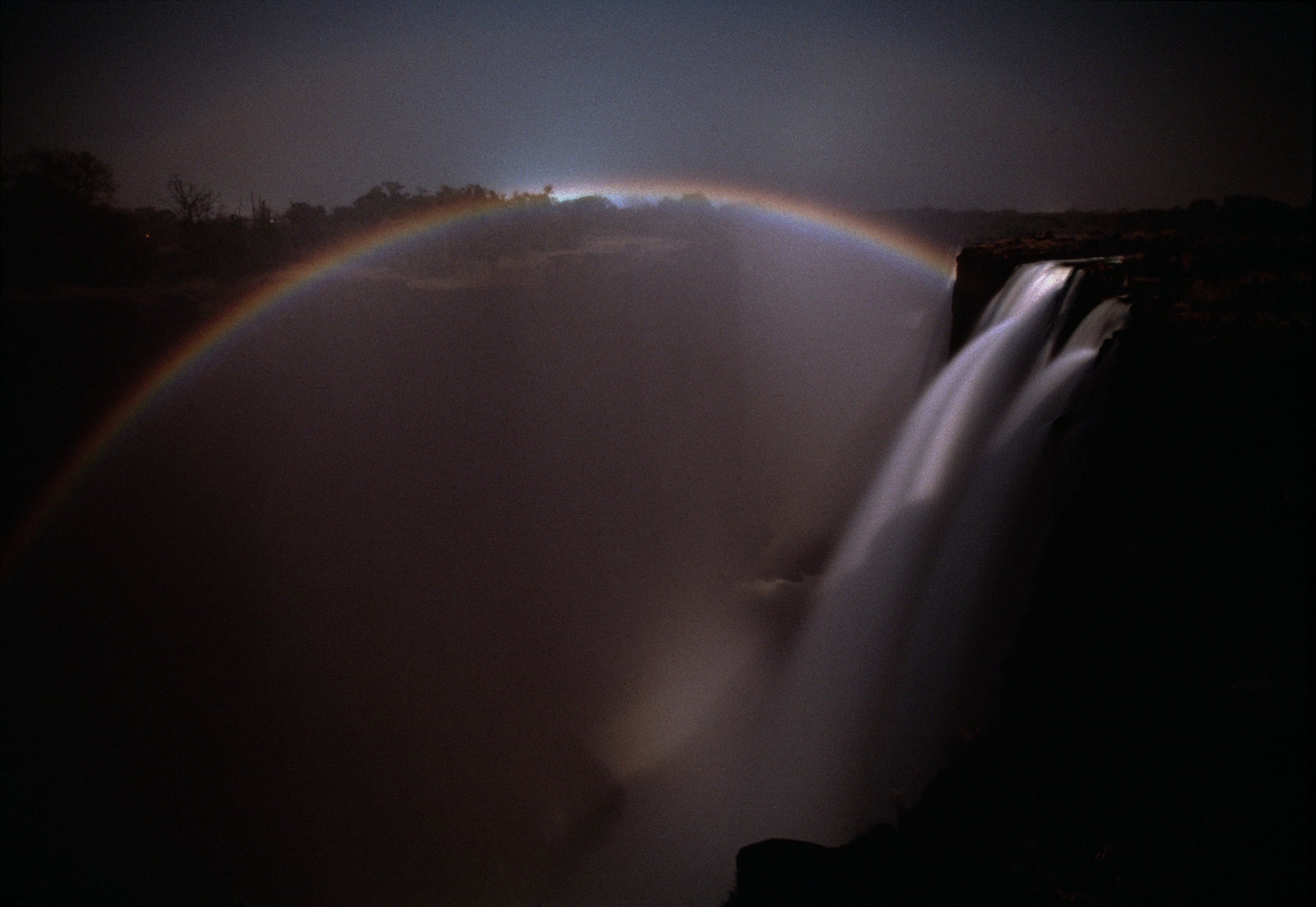 A moonbow arches over Victoria Falls, which are more than 5500 feet wide and 35 5 feet high.