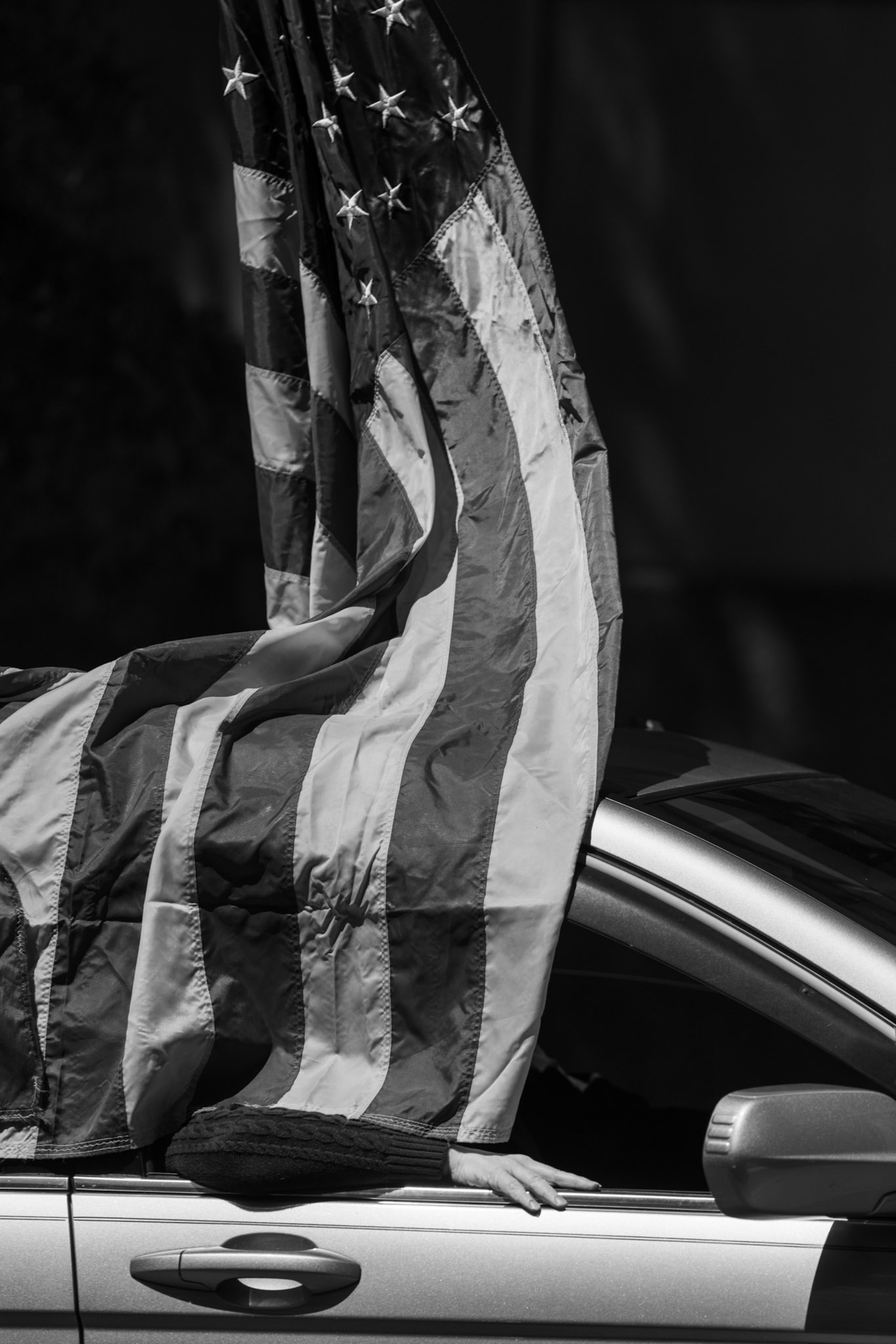 an American flag draped over a car