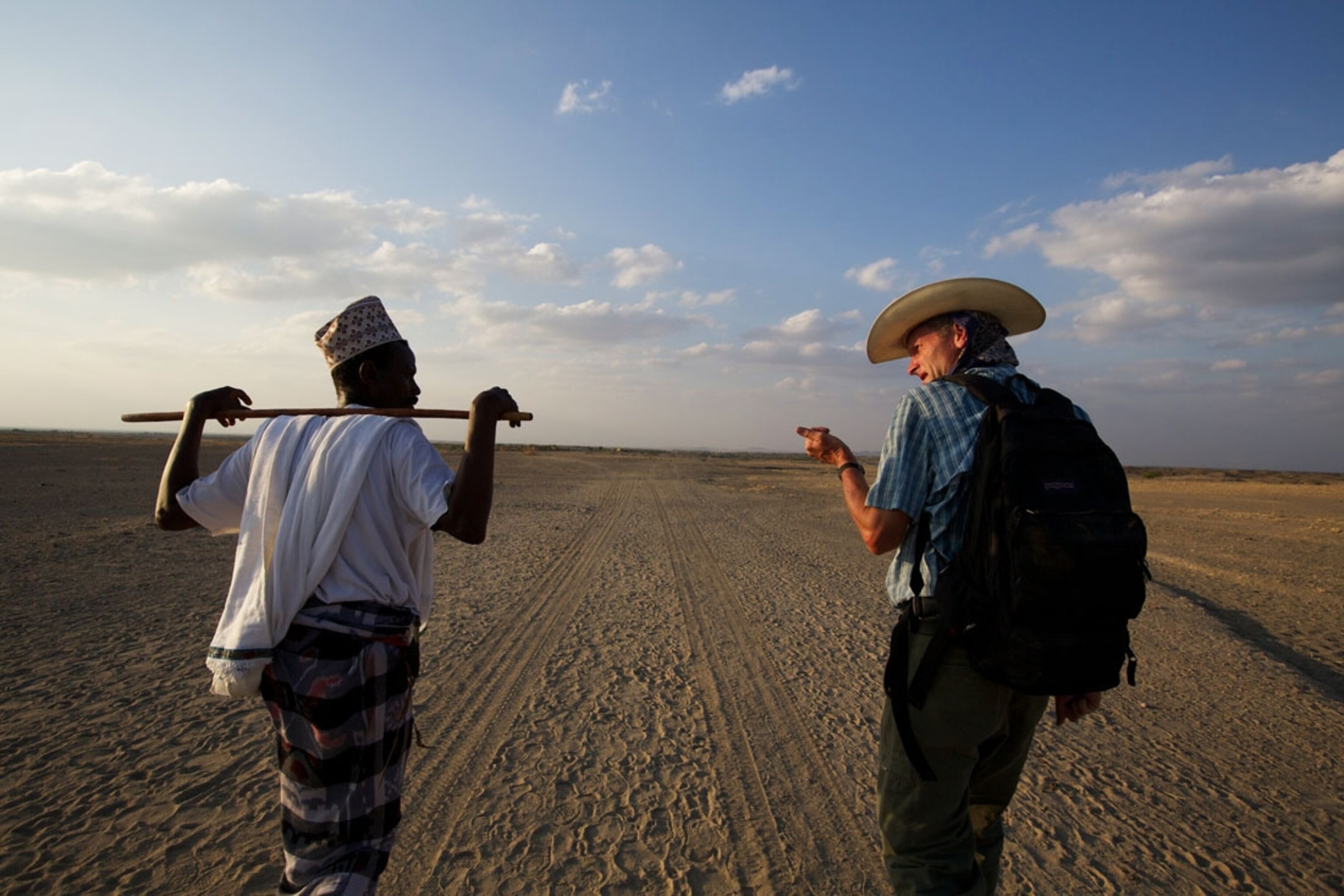 From “Let’s Walk,” the first Dispatch from the Out of Eden Walk. Paul Salopek and his Ethiopian guide, Ahmed Alema Hessan, leave the village of Bouri in the Afar region of northwestern Ethiopia.