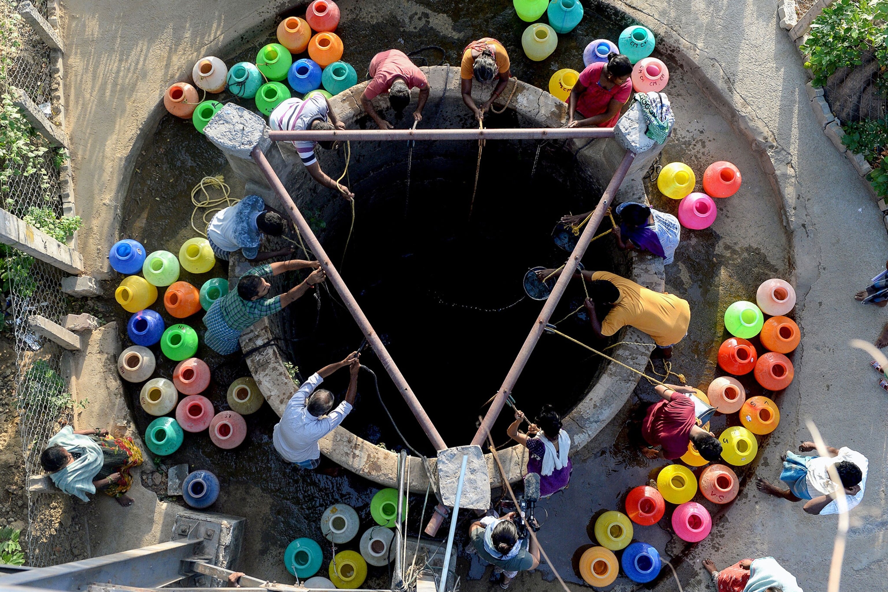 Indian residents get water from a community well in Chennai.