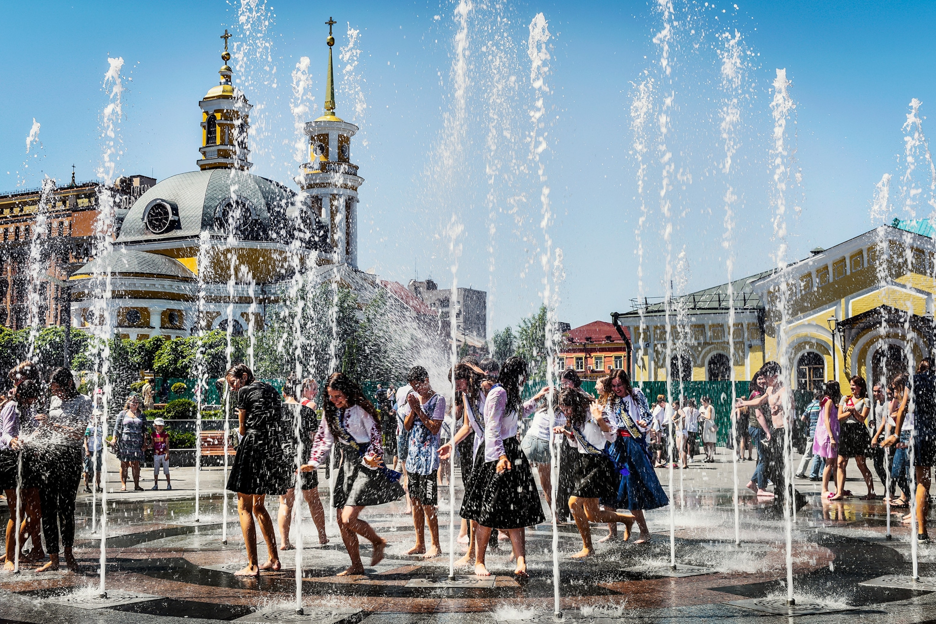kids playing in fountains after the last day of school in Kiev, Ukraine