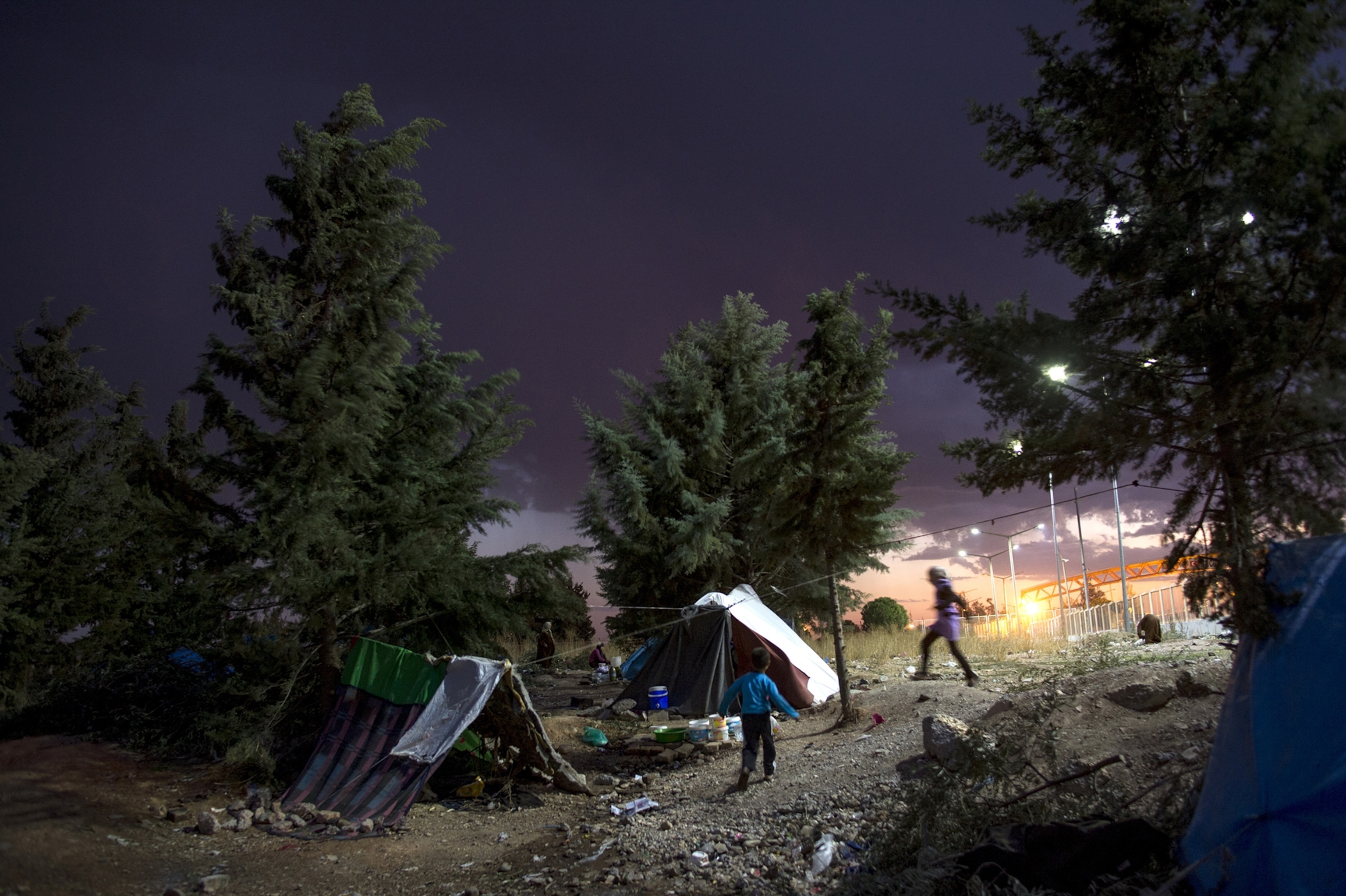 Syrian refugees live in squalid conditions with no aid in a squatters camp on the Turkish side of the Turkish Syrian border across from the Killis camp in Turkey, October 22, 2013.