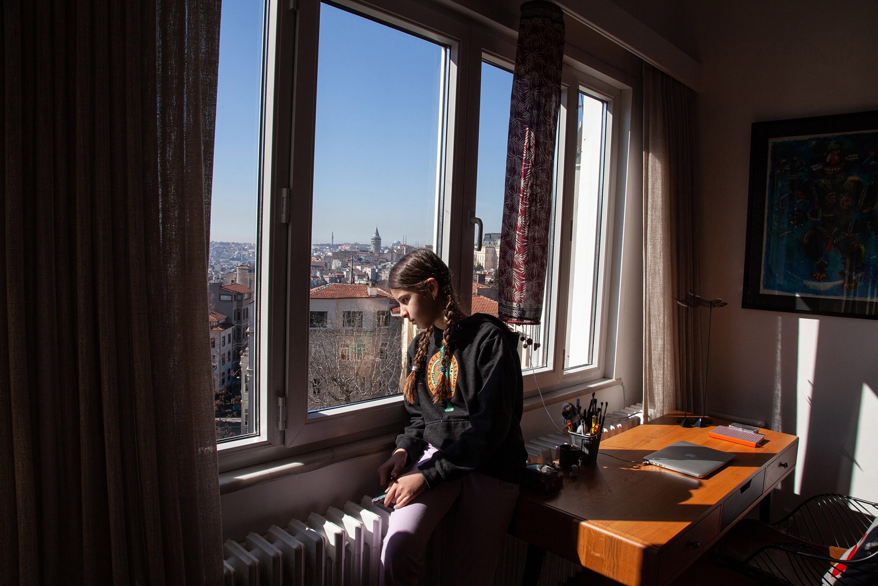 a young girl looking out a window
