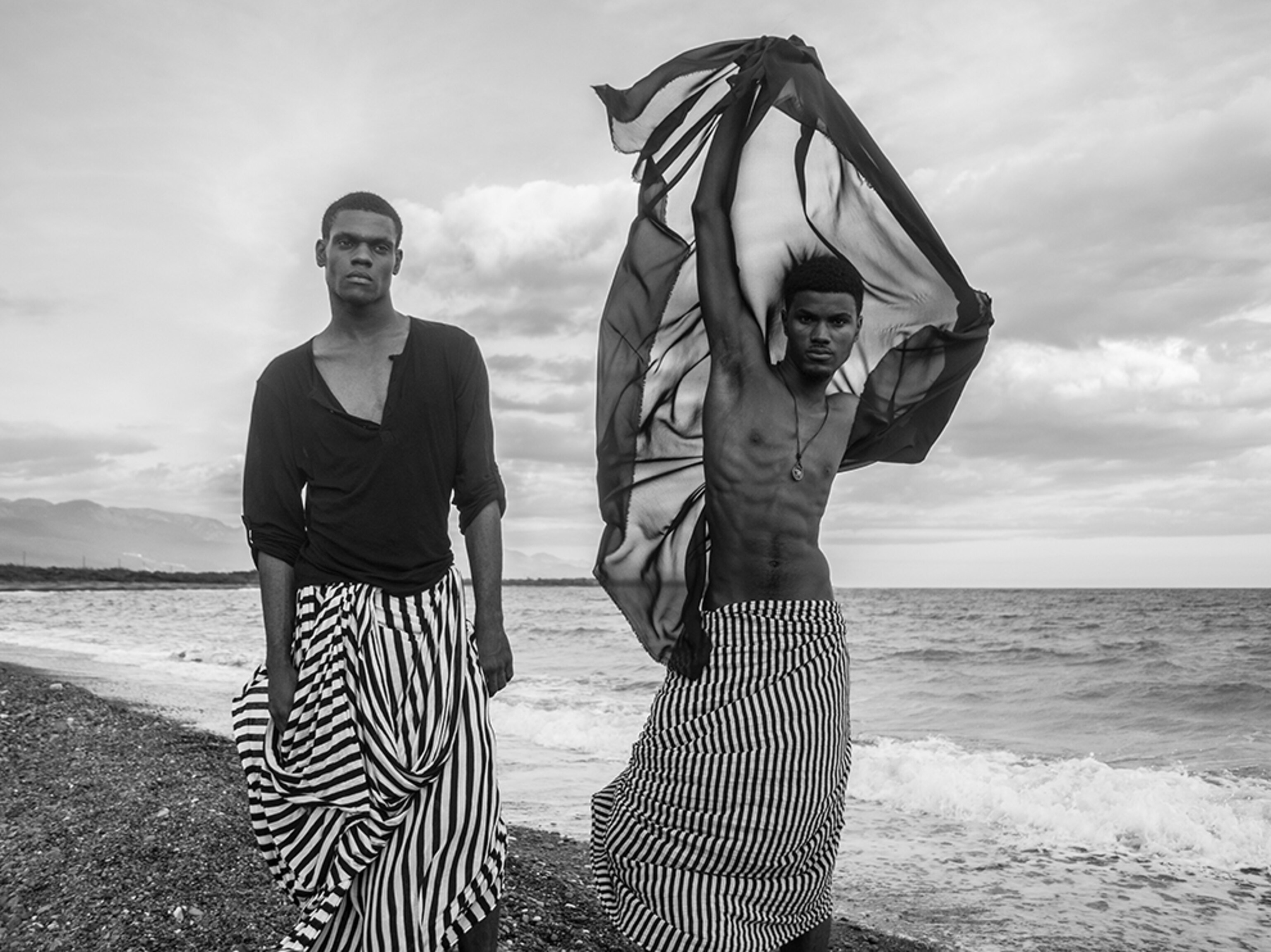 two male models walking along the beach, Port Royal, Jamaica