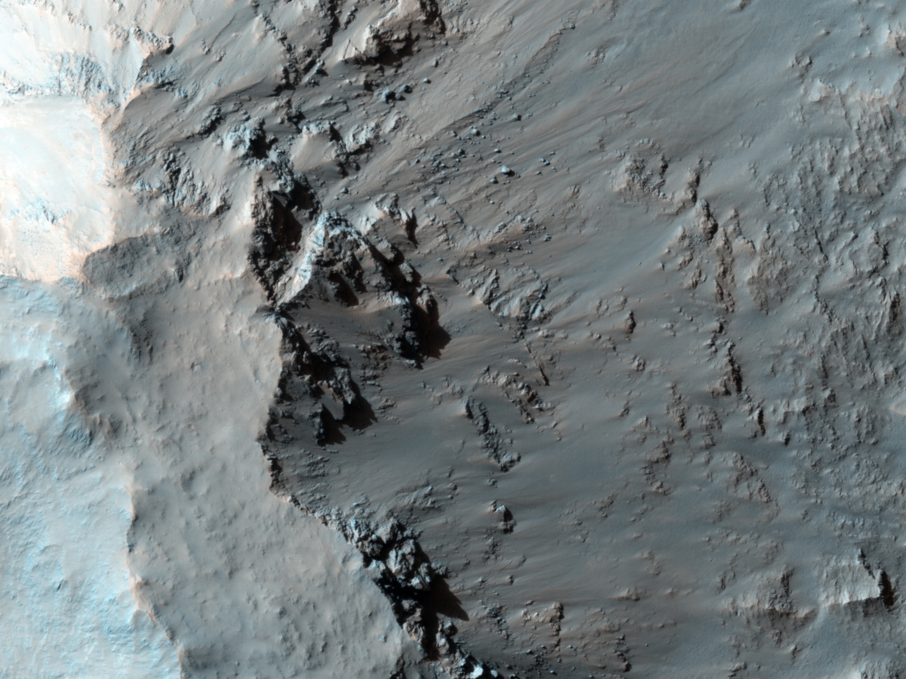 Elorza Crater is an approximately 40-kilometer diameter complex crater located at 304.8 degrees east, 8.76 degrees north, about 300 kilometers north of Coprates Chasma. This image centers on the southwestern portion of the central uplift, and is characterized by numerous bedrock exposures and coherent impact melt flows.