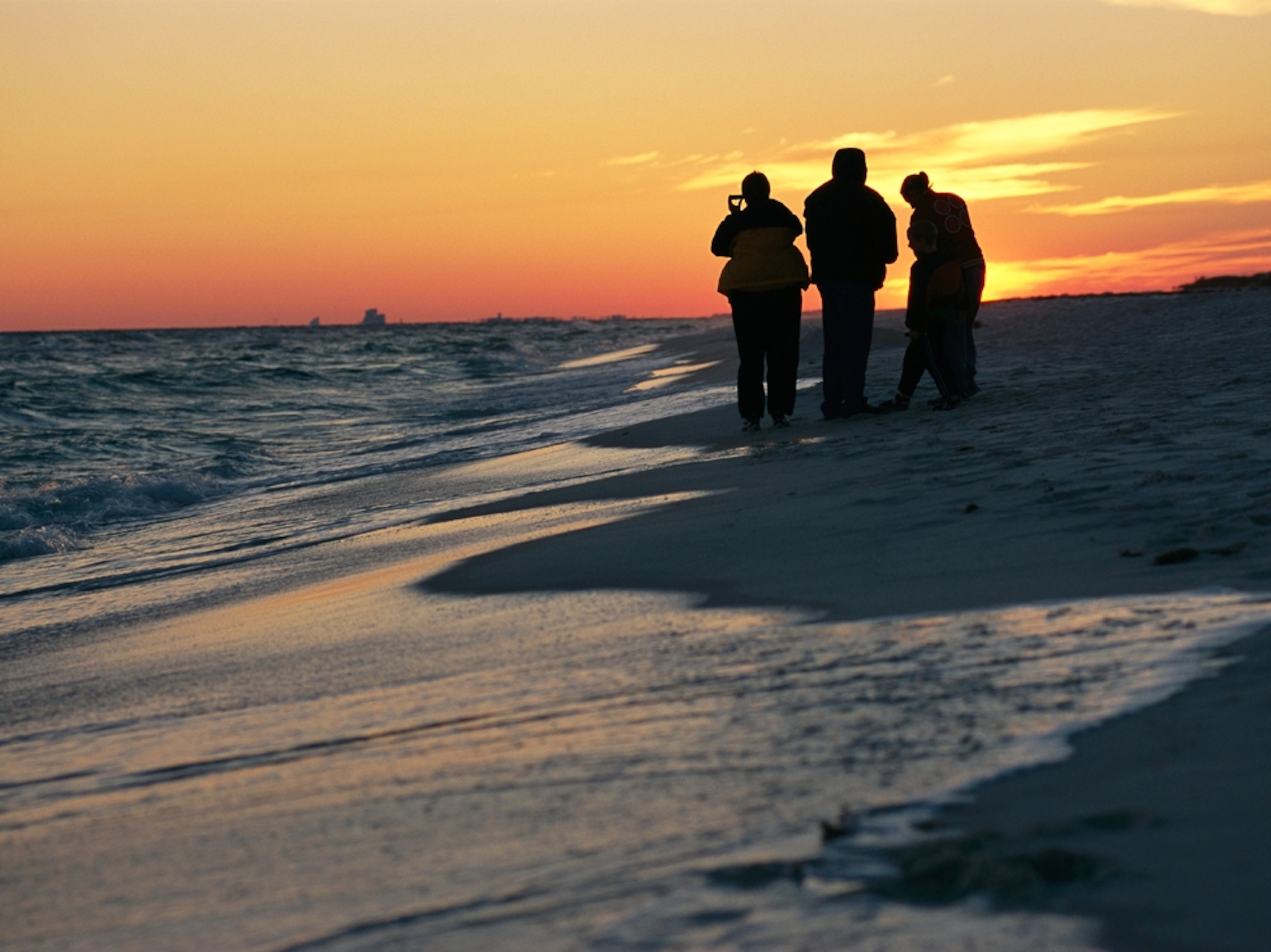 people watching the sunset from the shoreline at Gulf Islands National Seashore